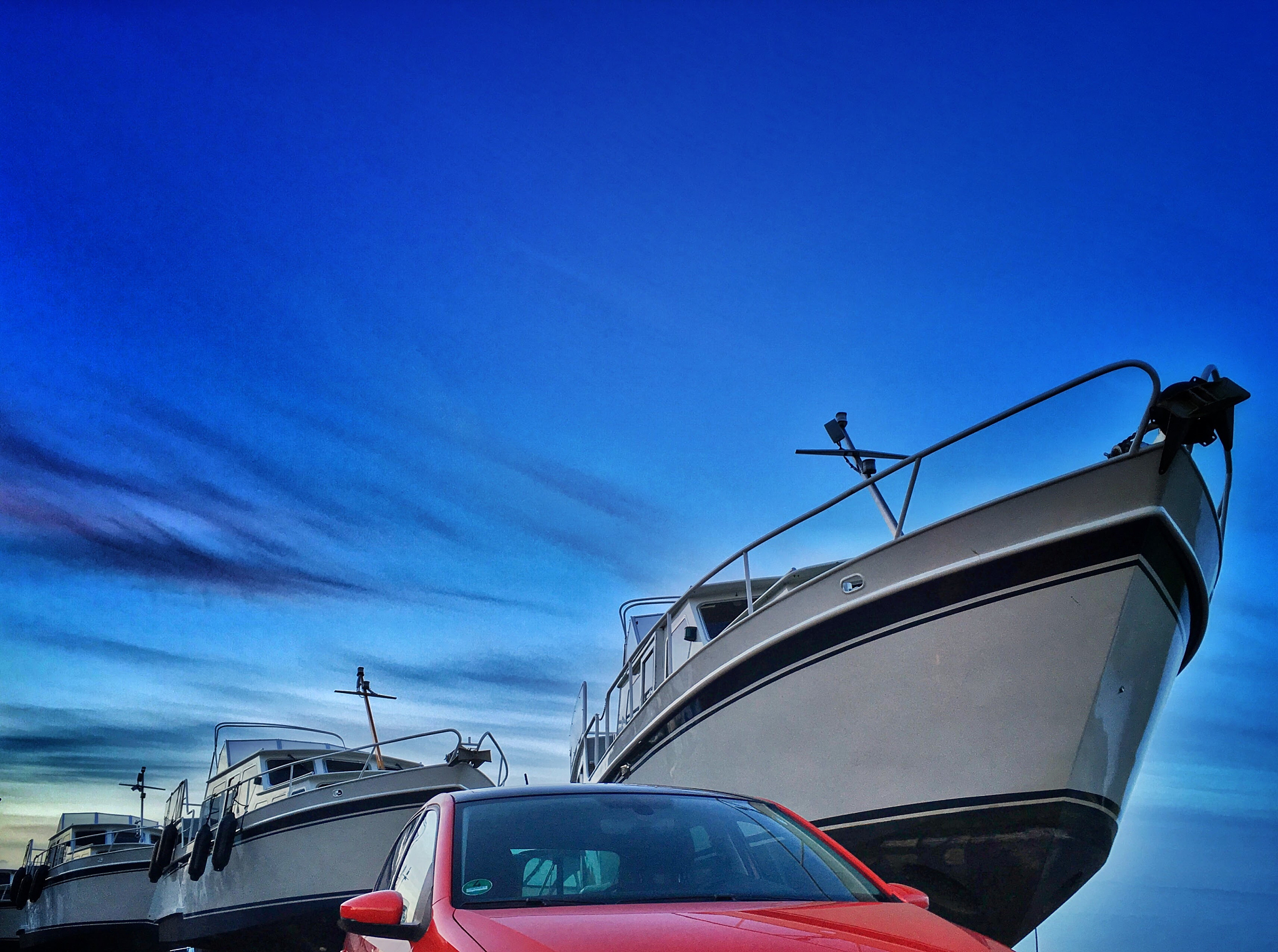 car and boats against sky