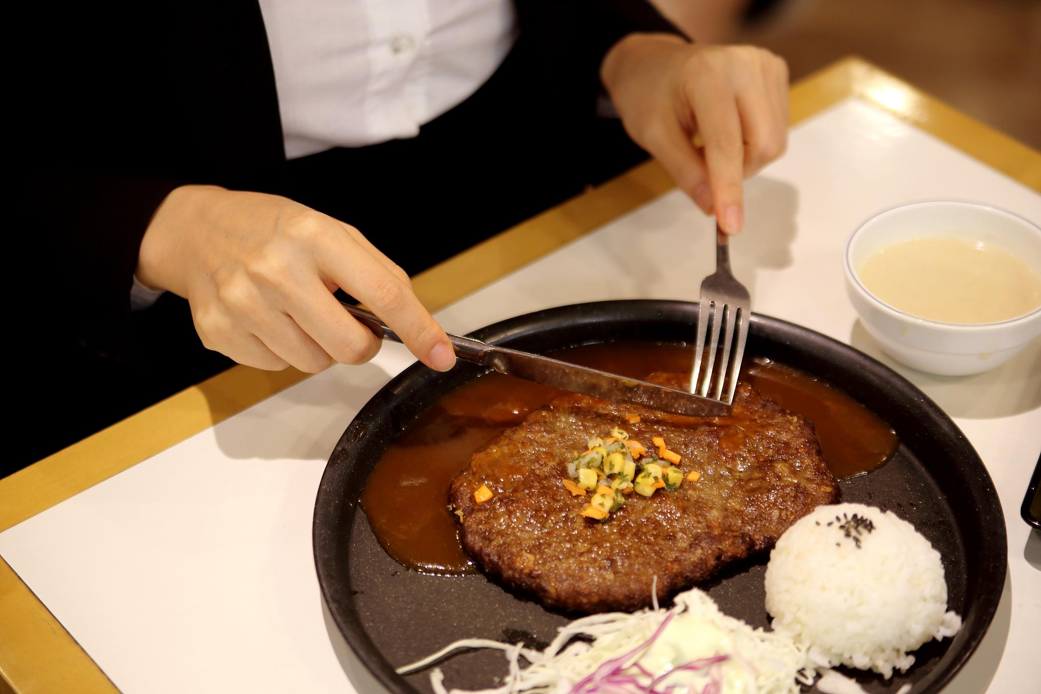 woman eating hamburger steak