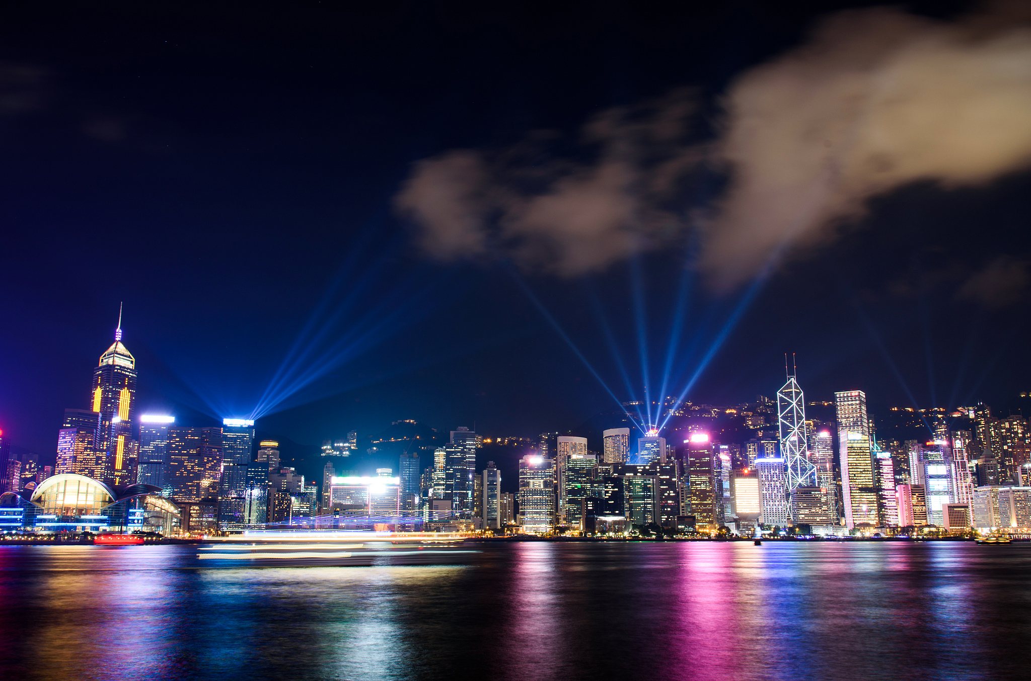 laser show over hong kong cityscape at downtown modern building 
