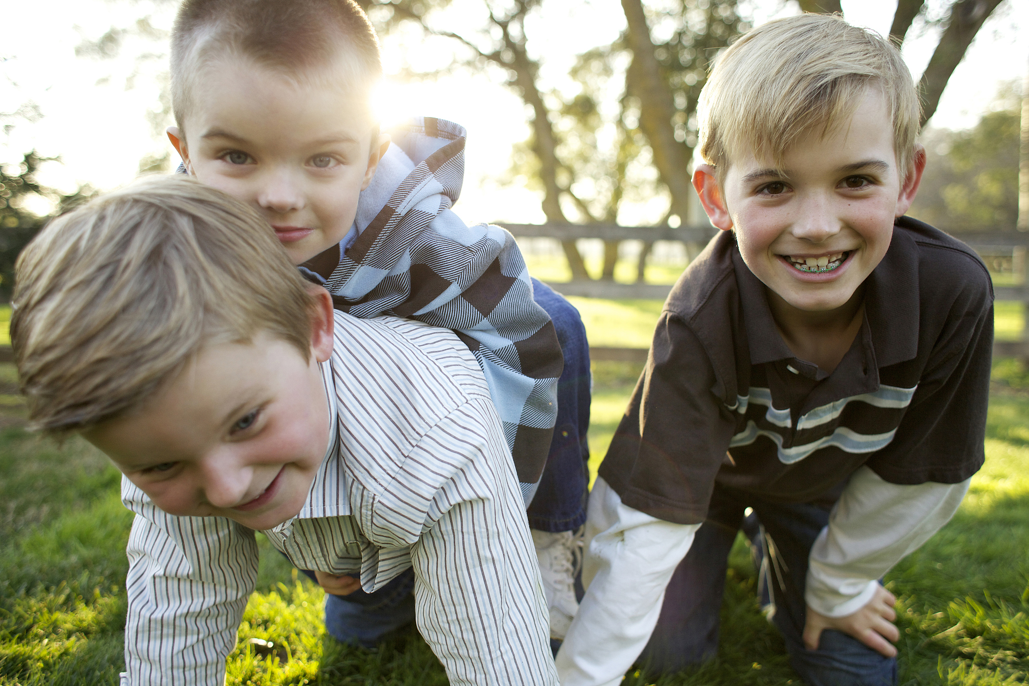 caucasian brothers playing in grass
