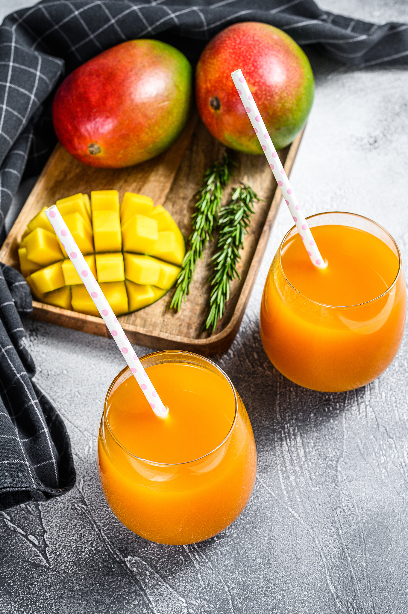 refreshing mango juice in a glass. gray background. top view