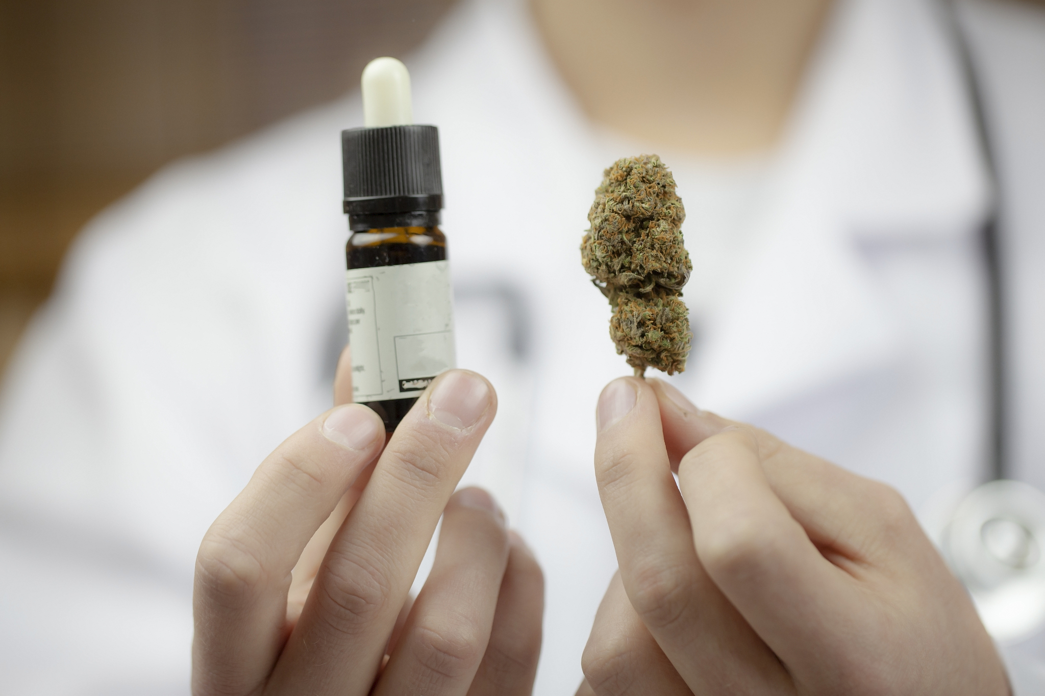 doctor holding legal marijuana and cbd oil