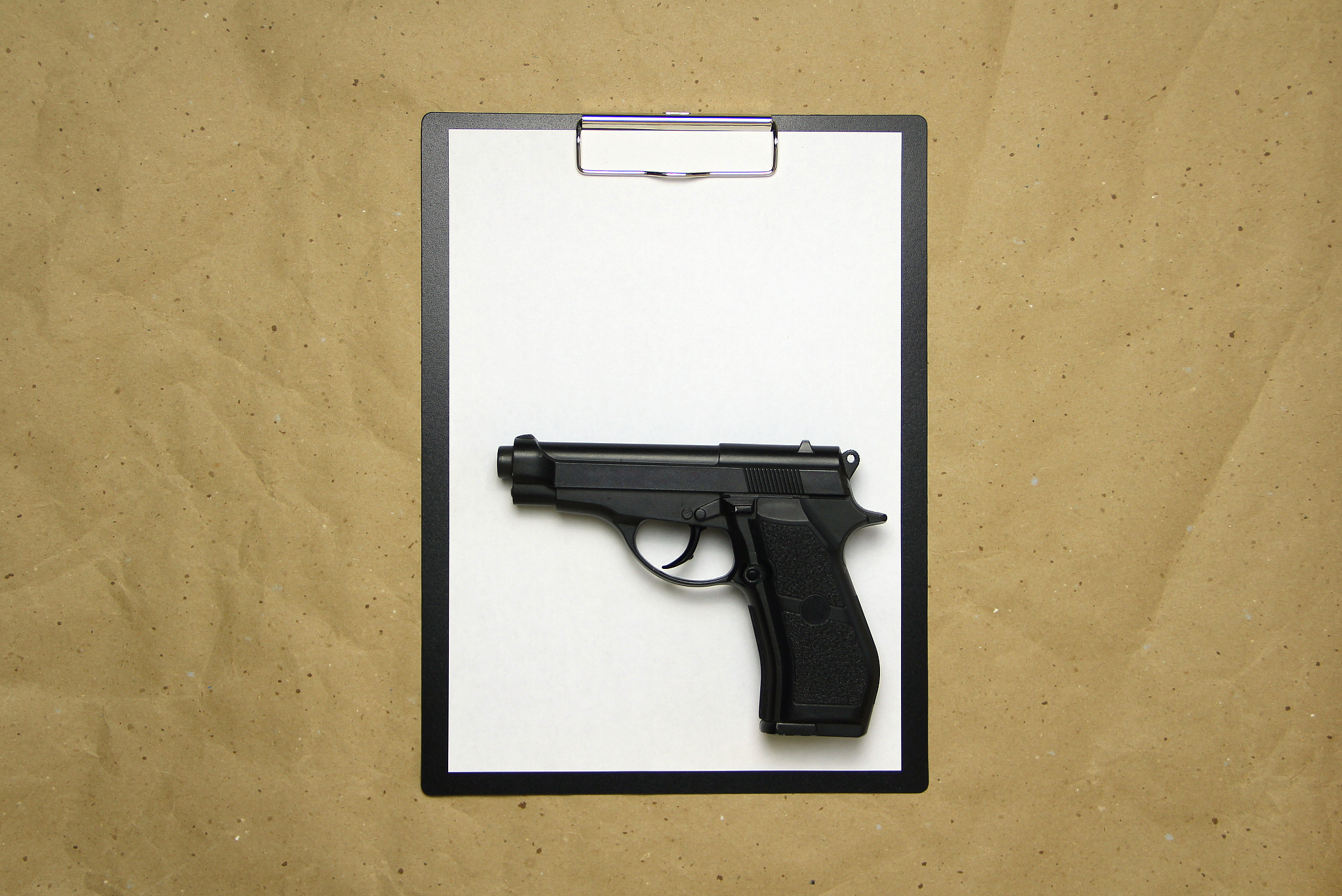 a tablet with a white sheet of a4 format on a beige craft paper
