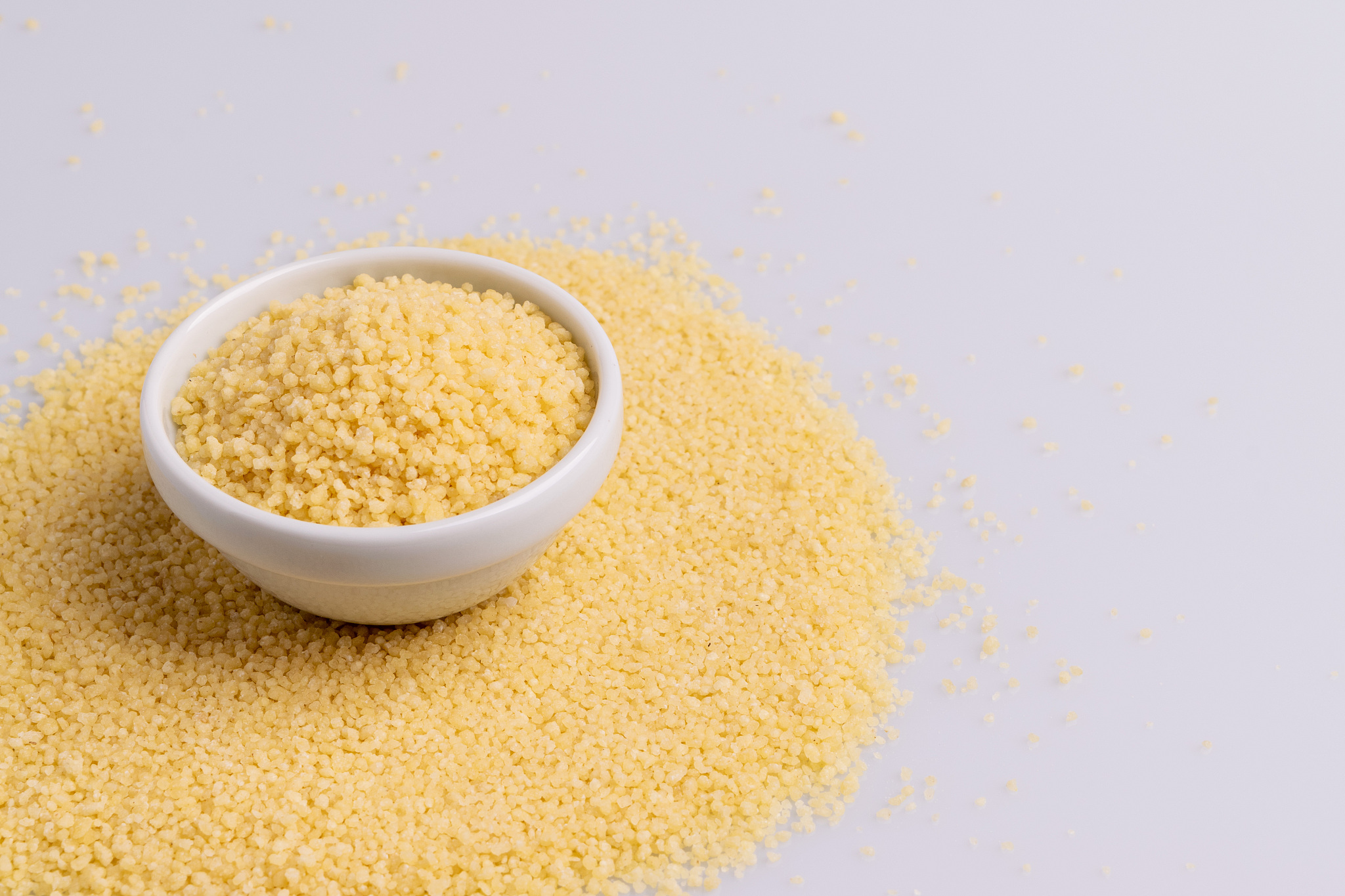 dry couscous isolated on white background, soft light, copy spac