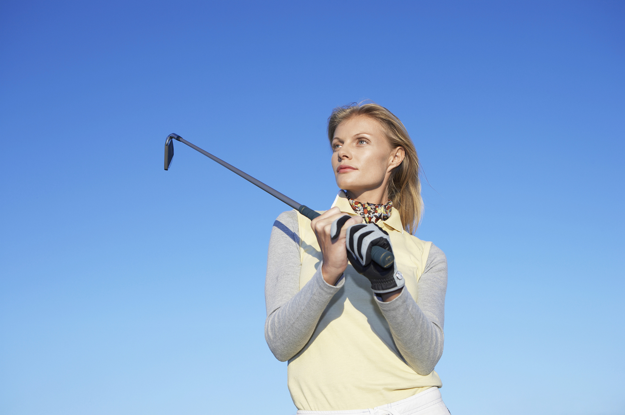woman swinging a golf club