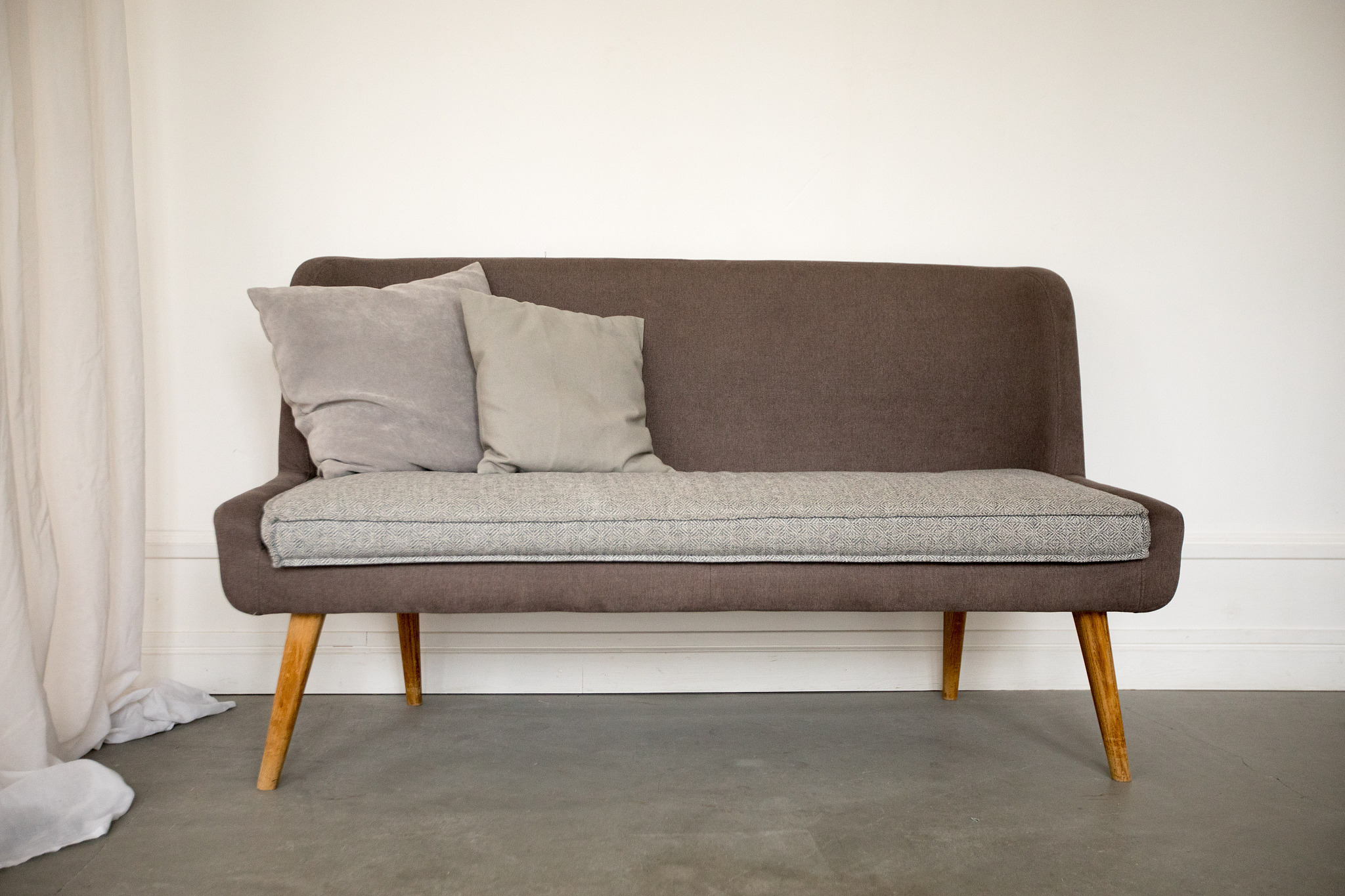 simple brown and grey sofa with wooden legs