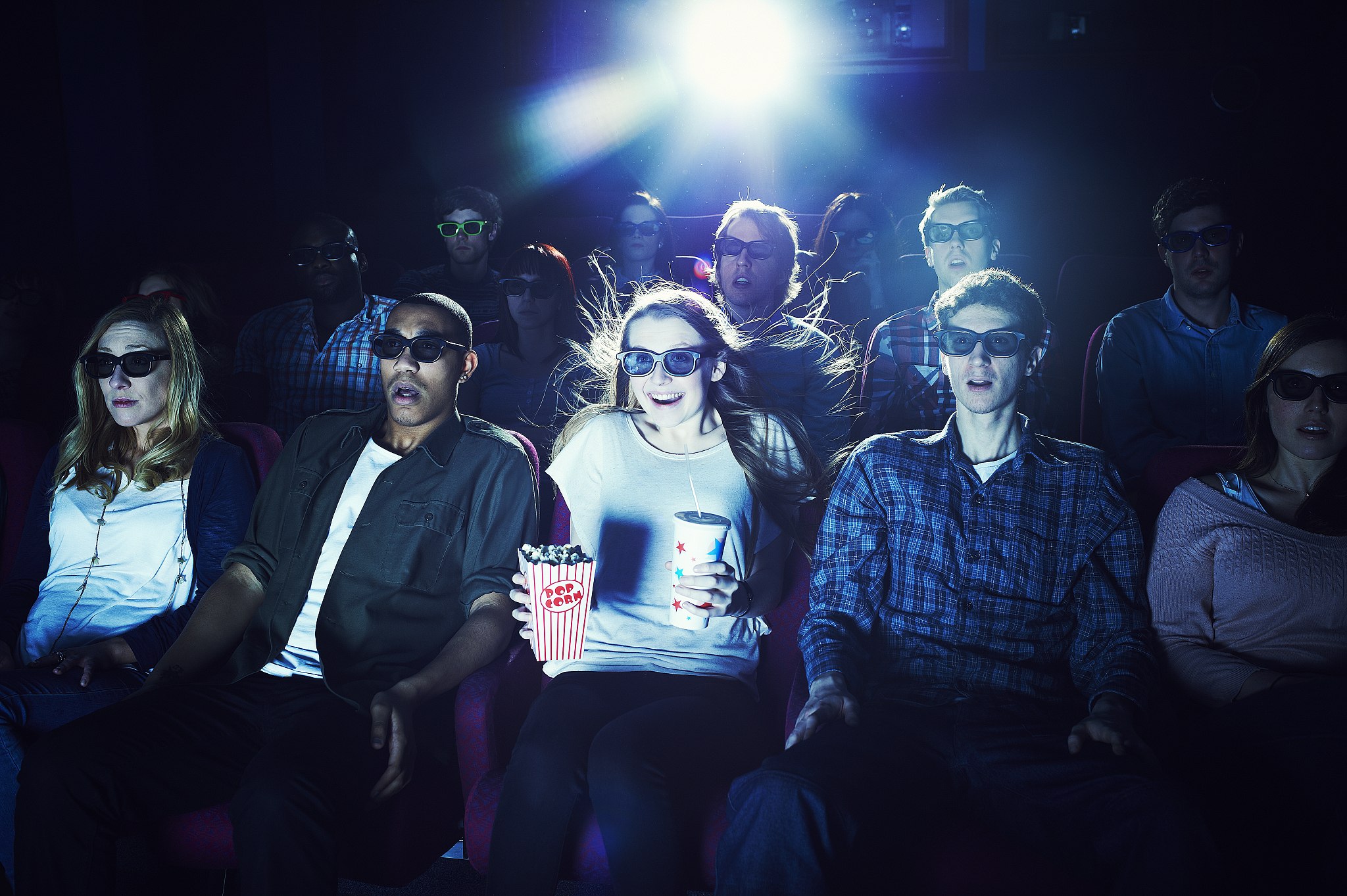 group of people wearing 3d glasses at the movies