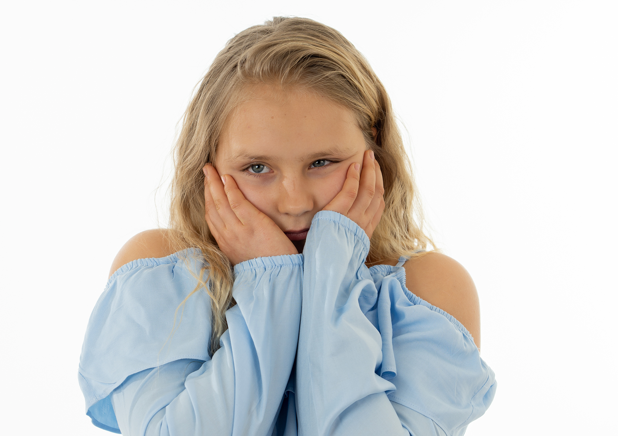close up portrait of a cute young shy girl looking timid at the 
