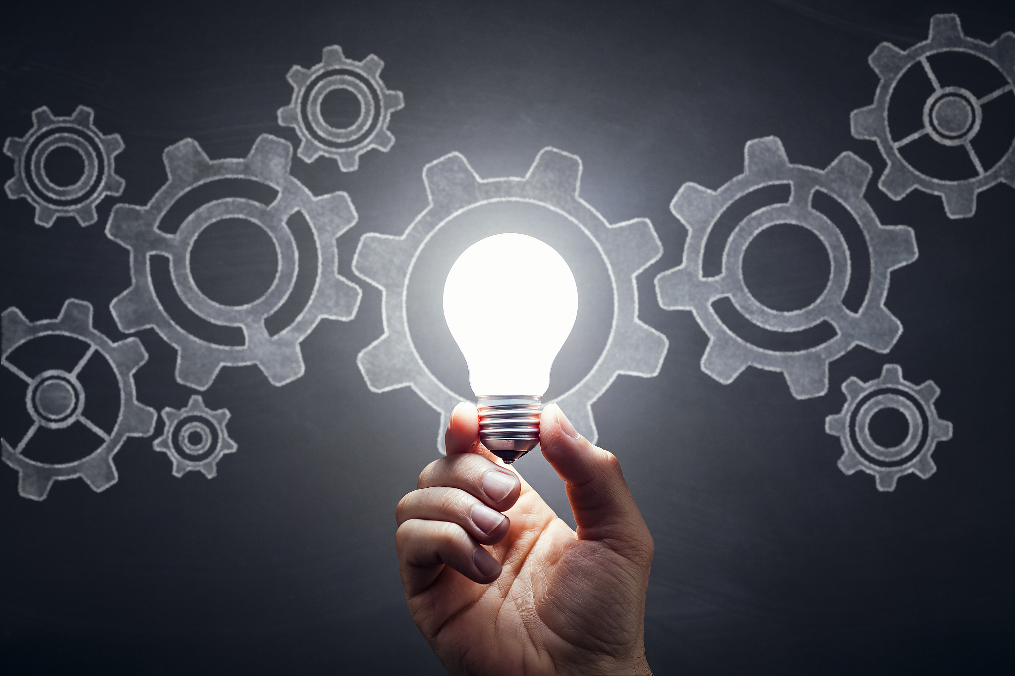 gears - light bulb hand idea blackboard