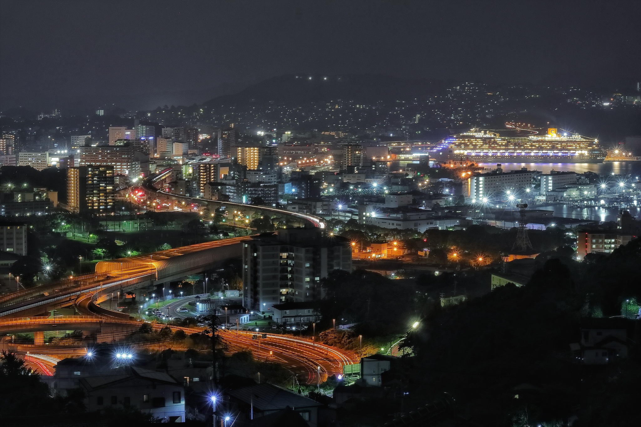 high angle view of illuminated buildings in city at night