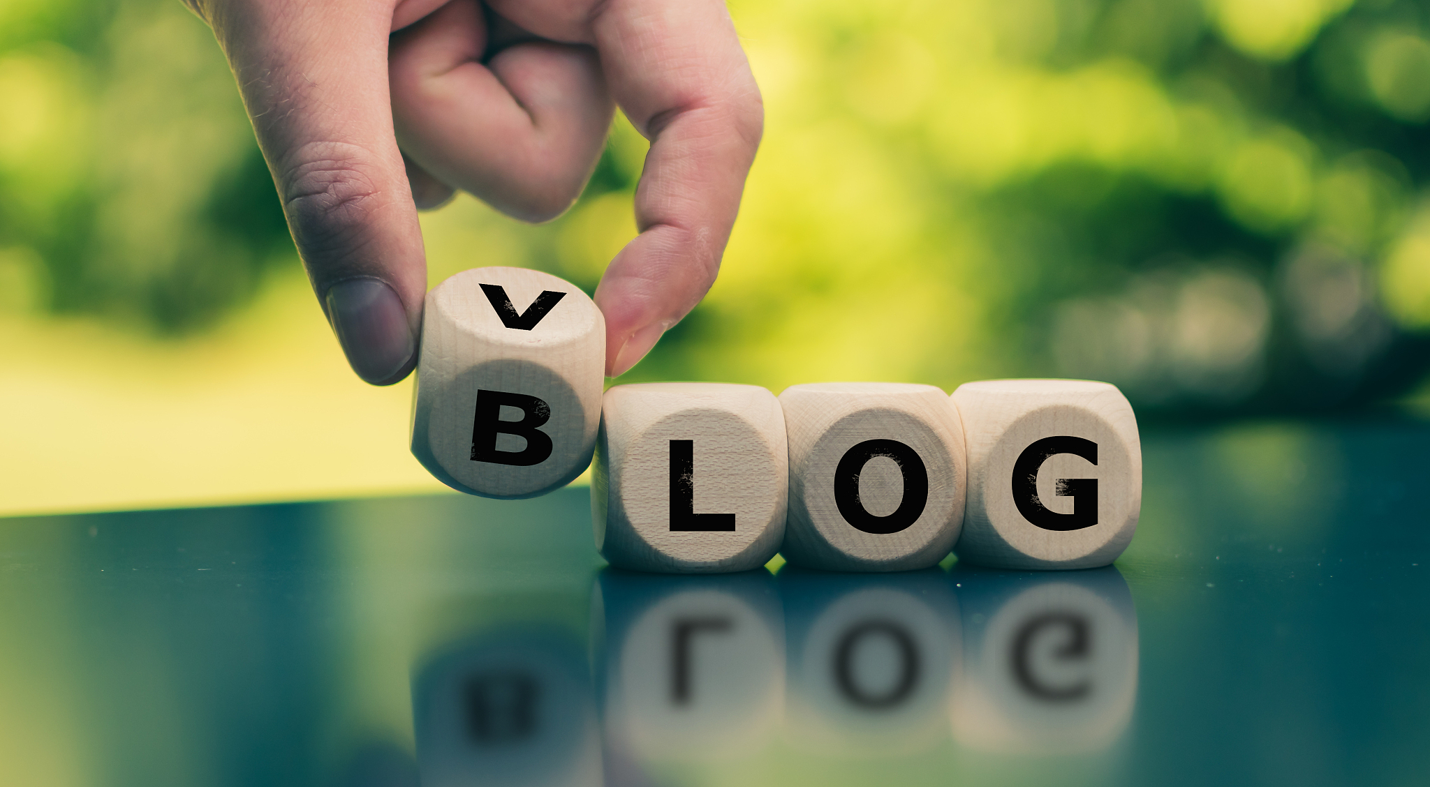 blog or vlog? hand turns a cube and changes the expression "blog