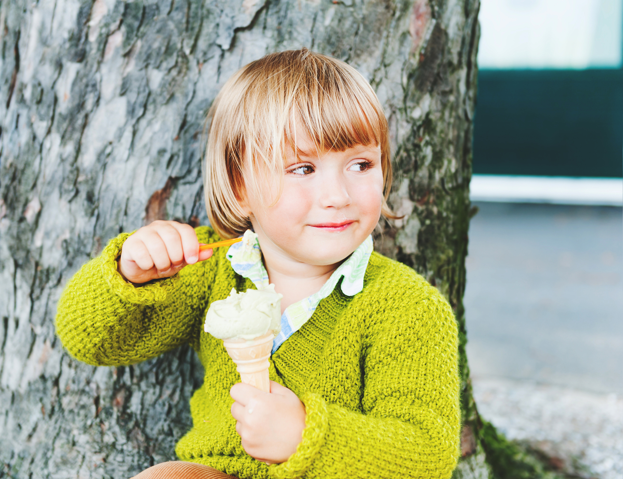 portrait of a cute toddler boy eating ice cream