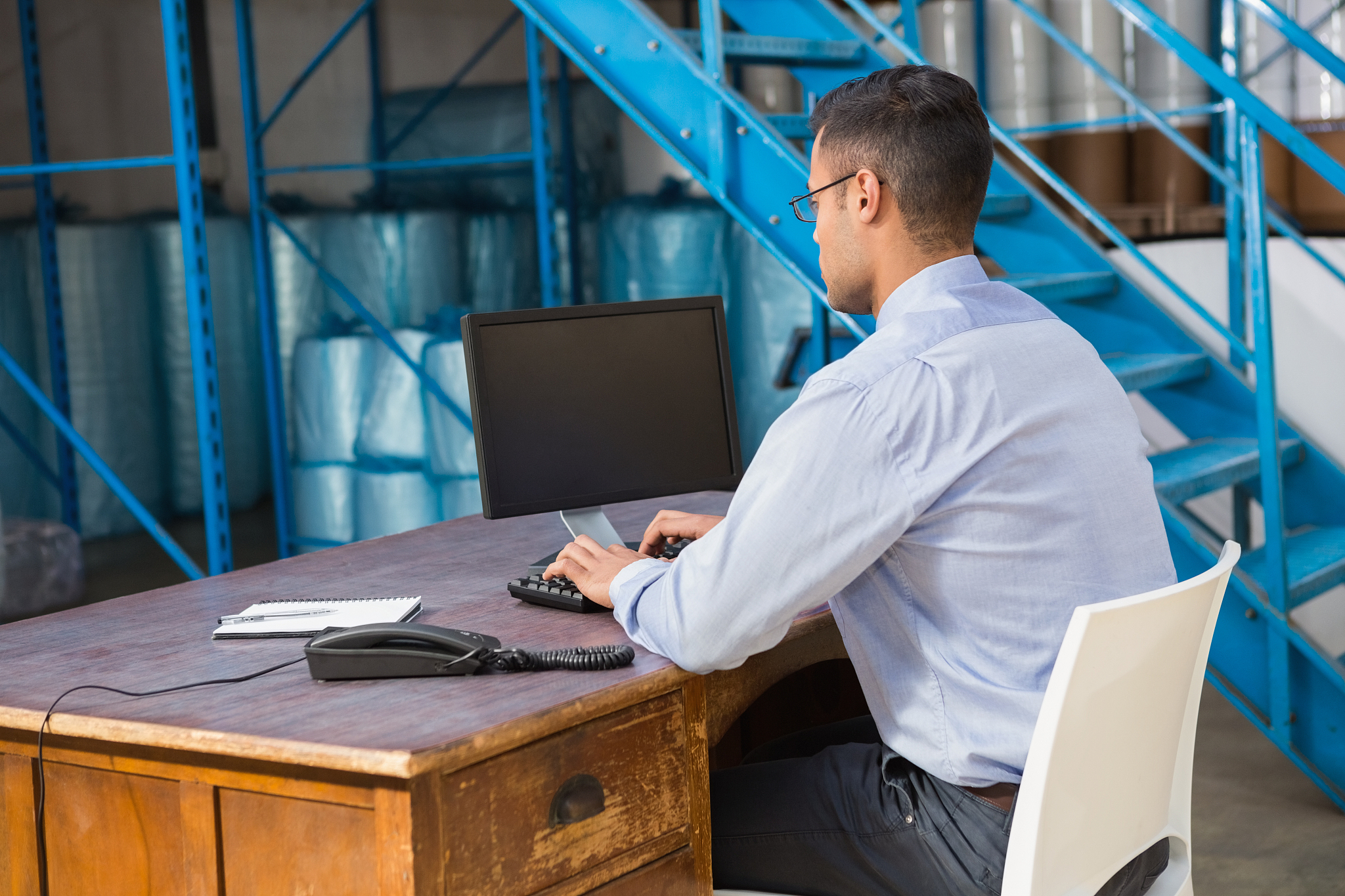 warehouse manager working on computer