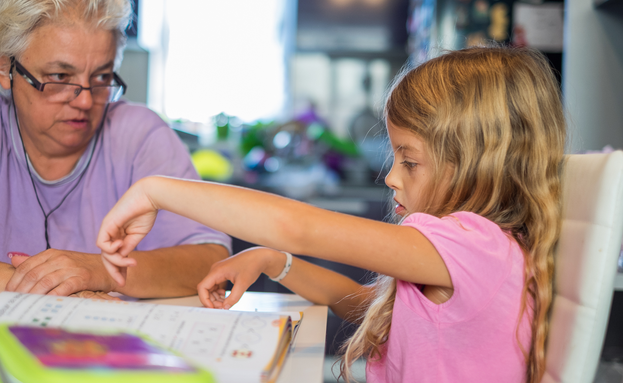 grandmother and granddaughter doing homework