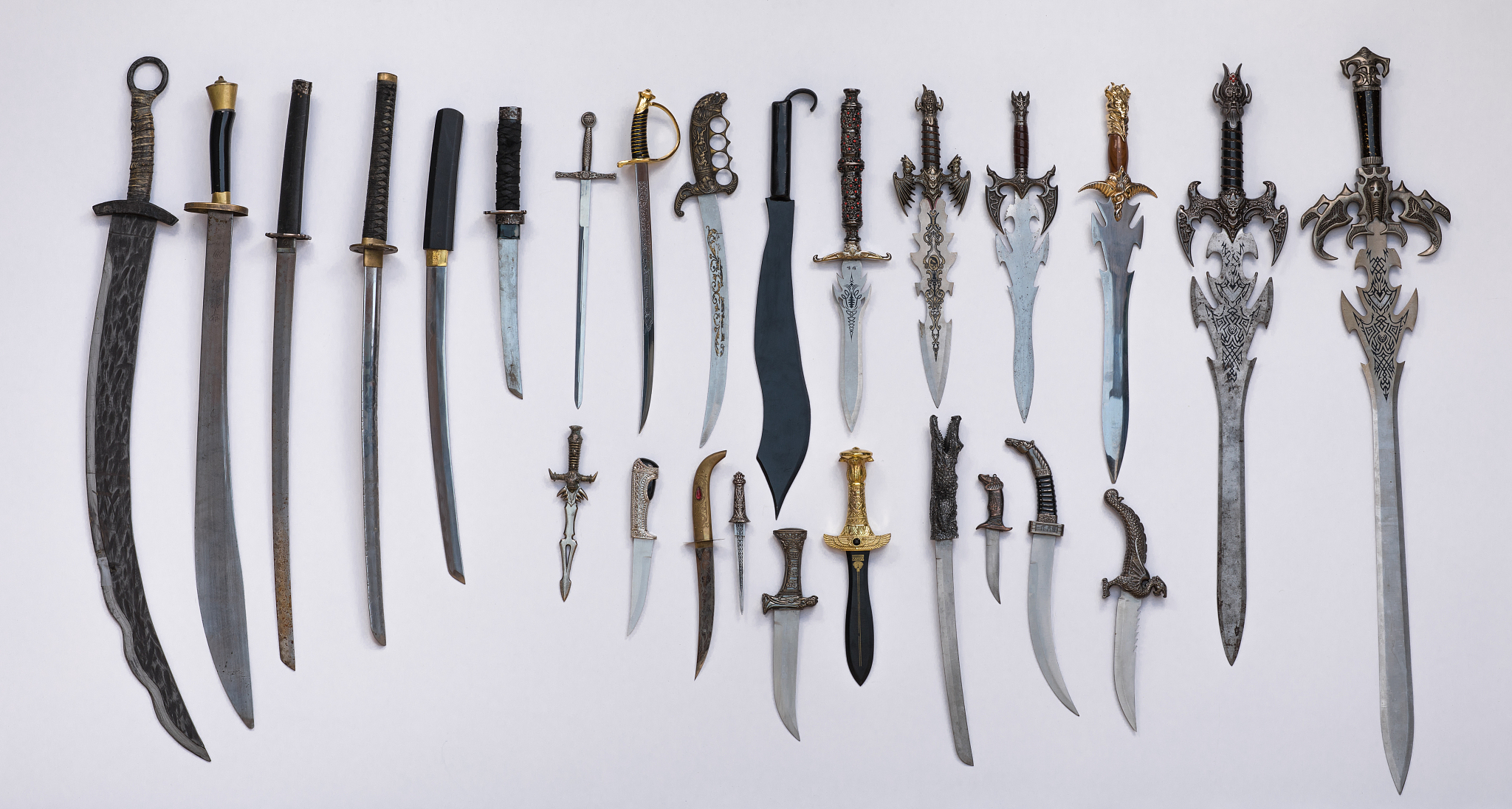 collection of medieval swords, knives and daggers
