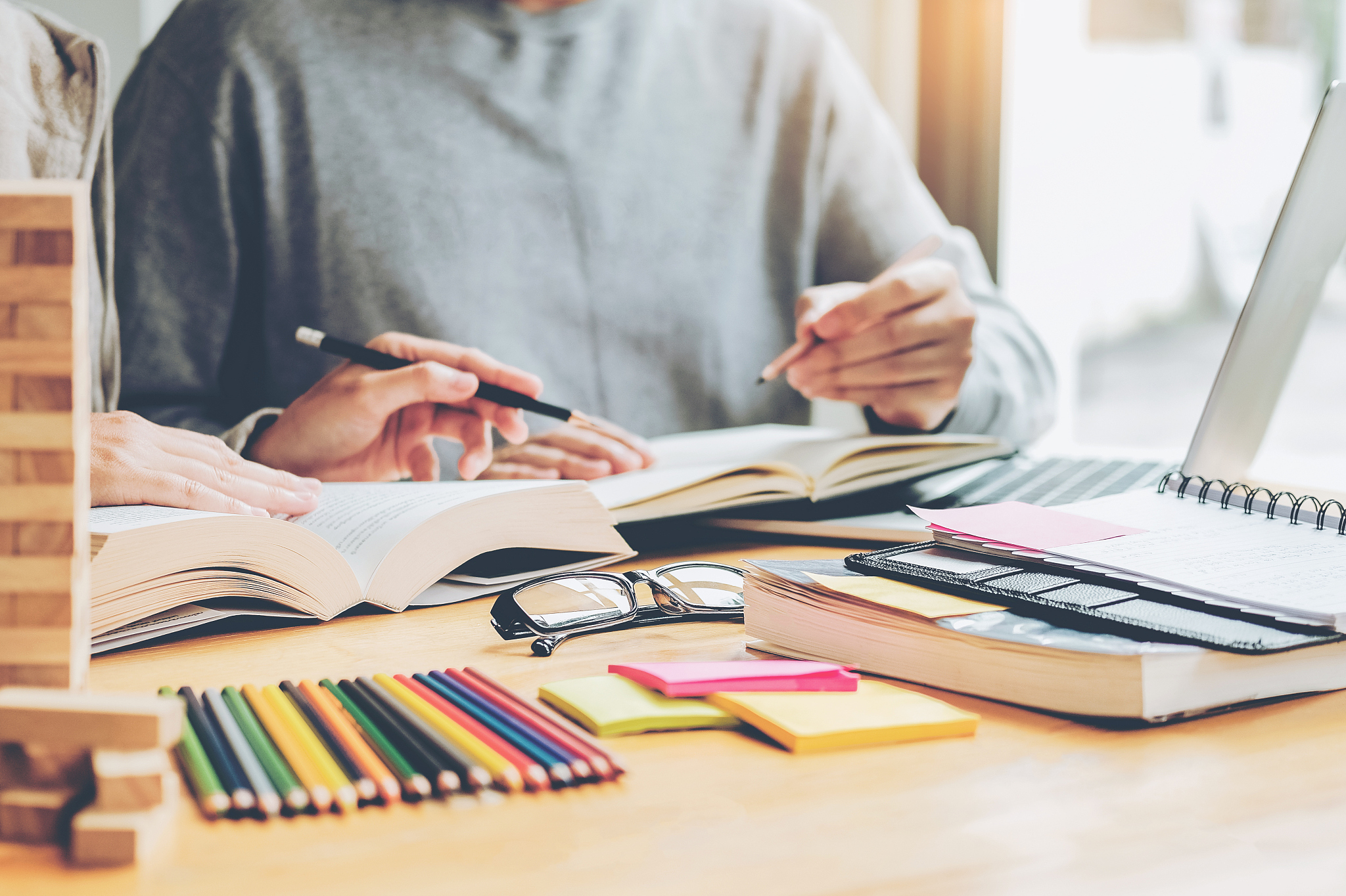 high school or college students studying and reading together in