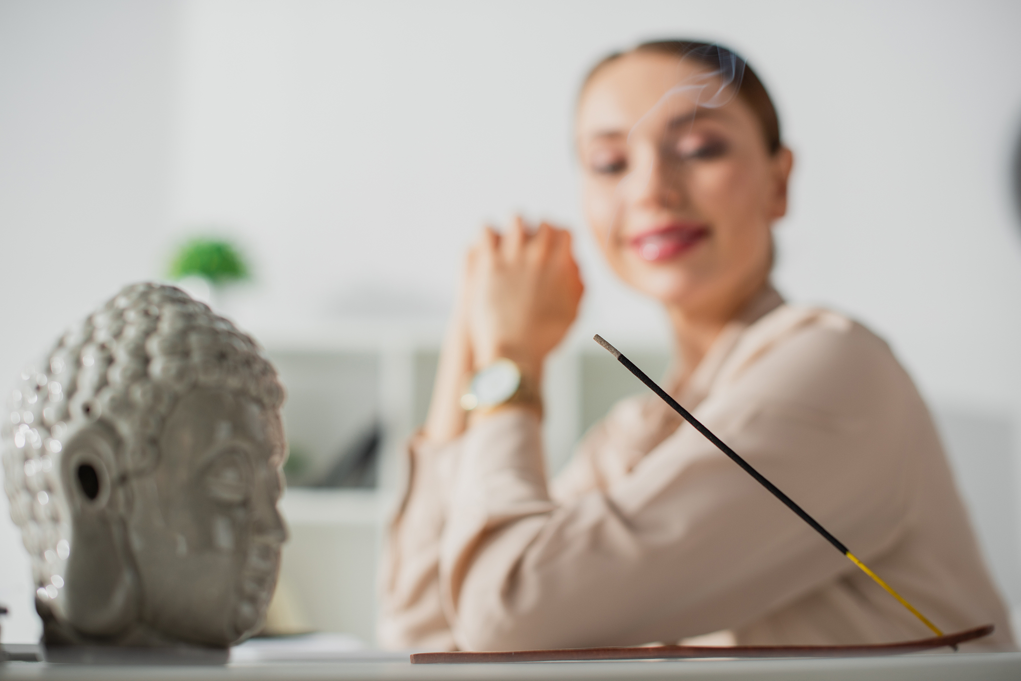 selective focus of happy businesswoman sitting in office with bu