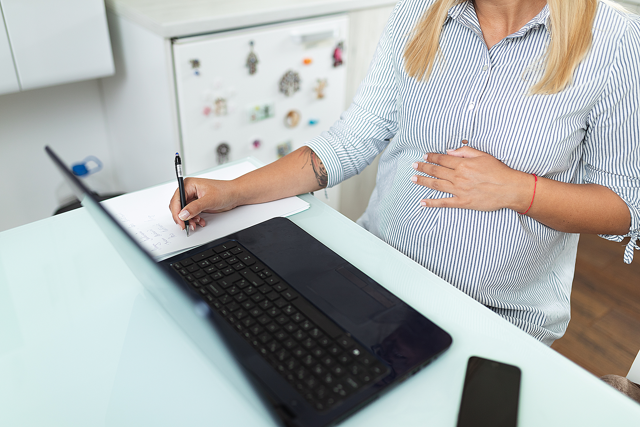 young pregnant woman using laptop