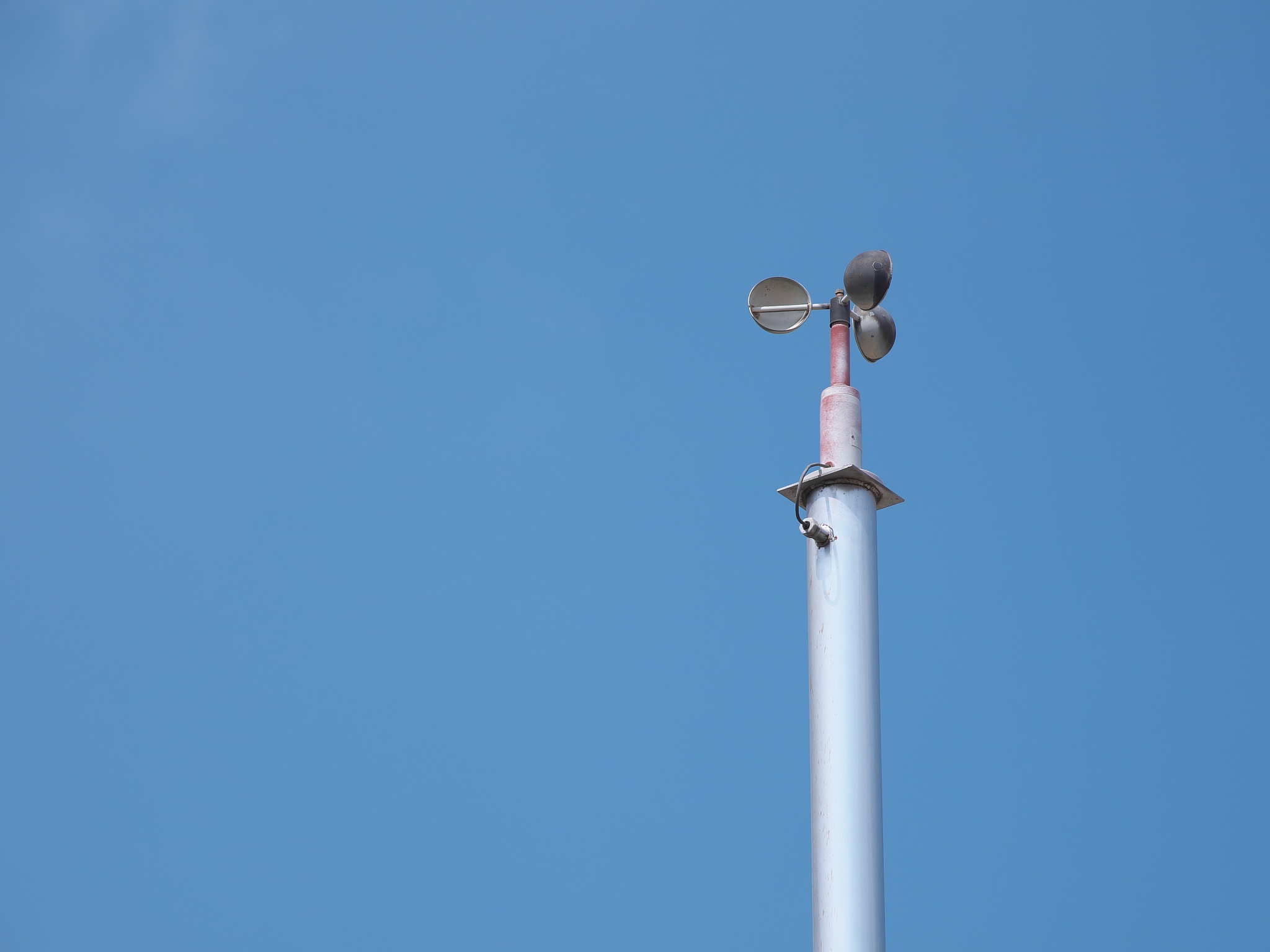 an anemometer or air speedometer on blue sky background