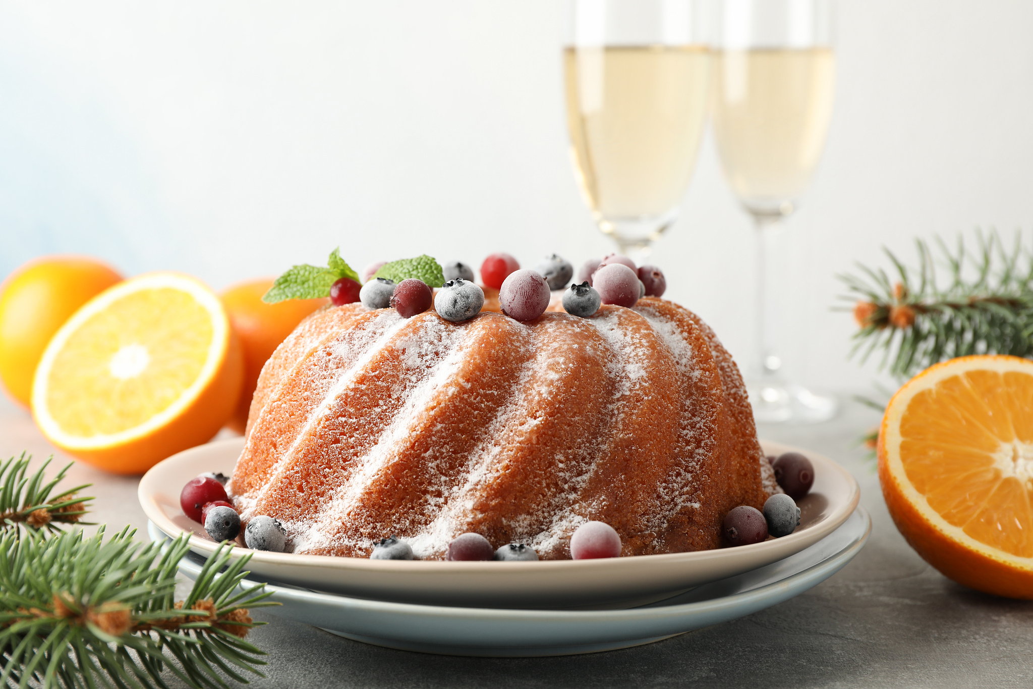 cake with powder sugar and berries on grey table. happy new year