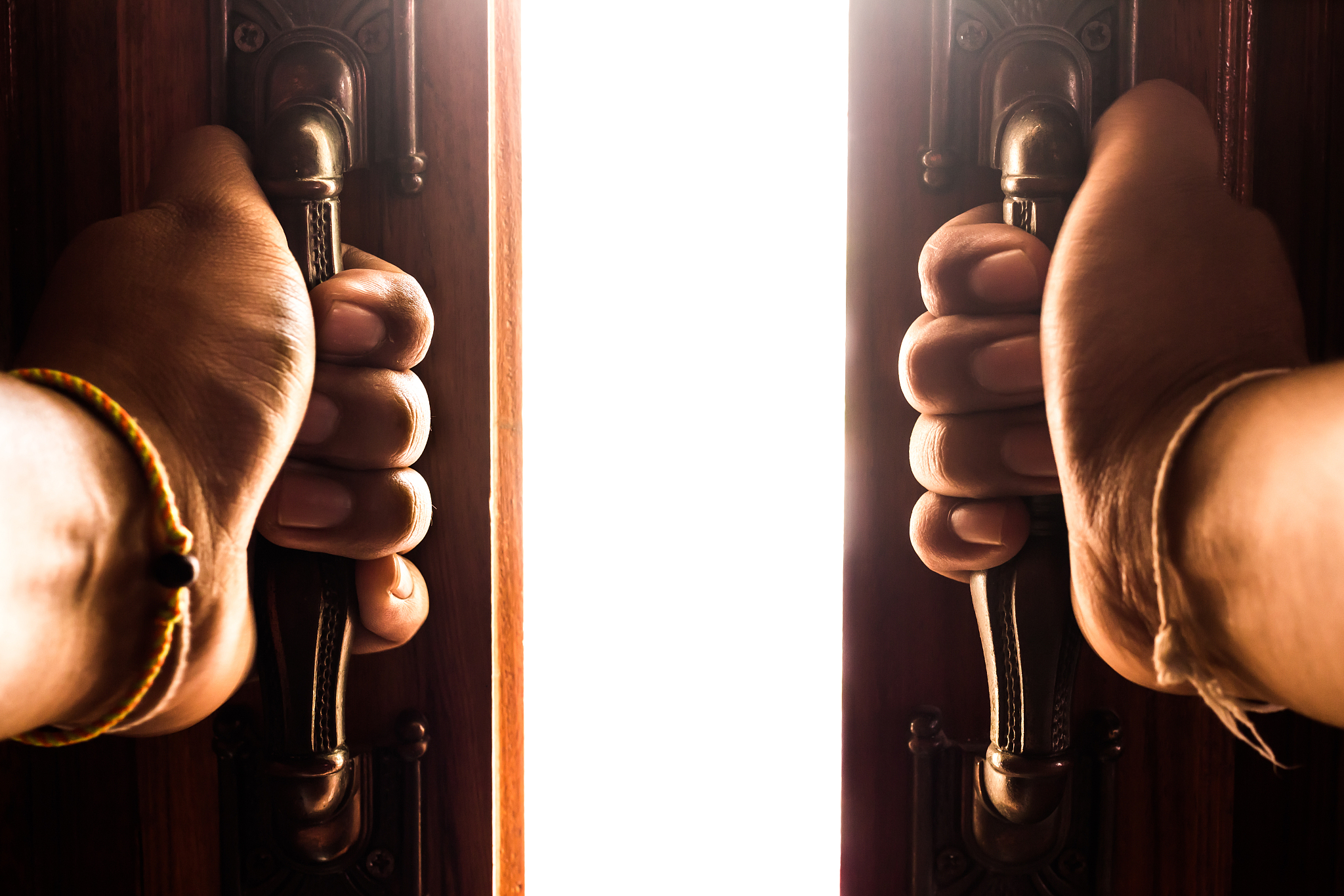 cropped hands opening door