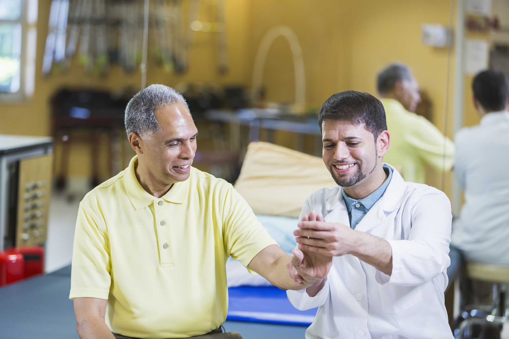 hispanic physical therapist, african american patient