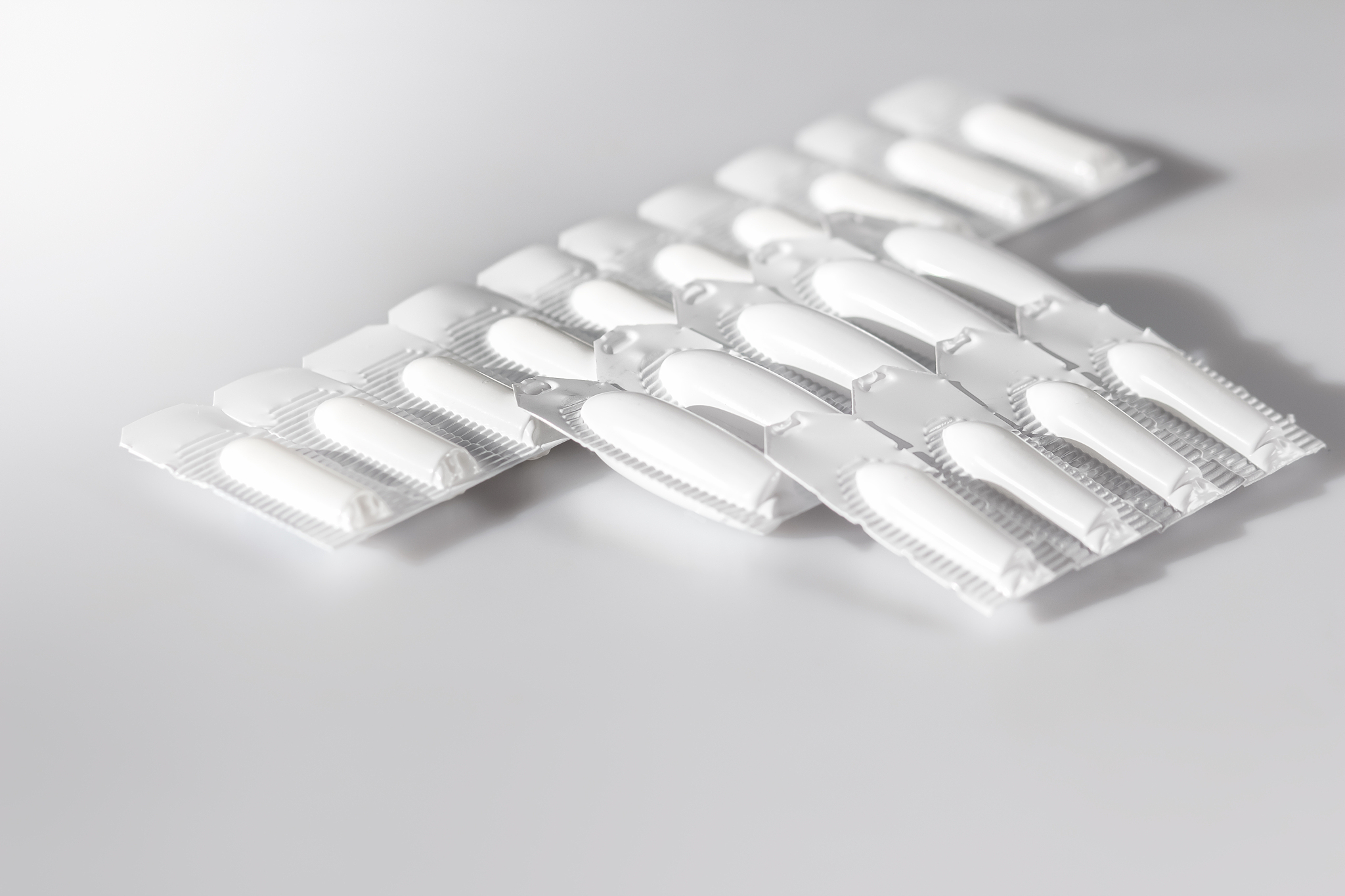 white medical suppositories in blister strip - pills on white ba