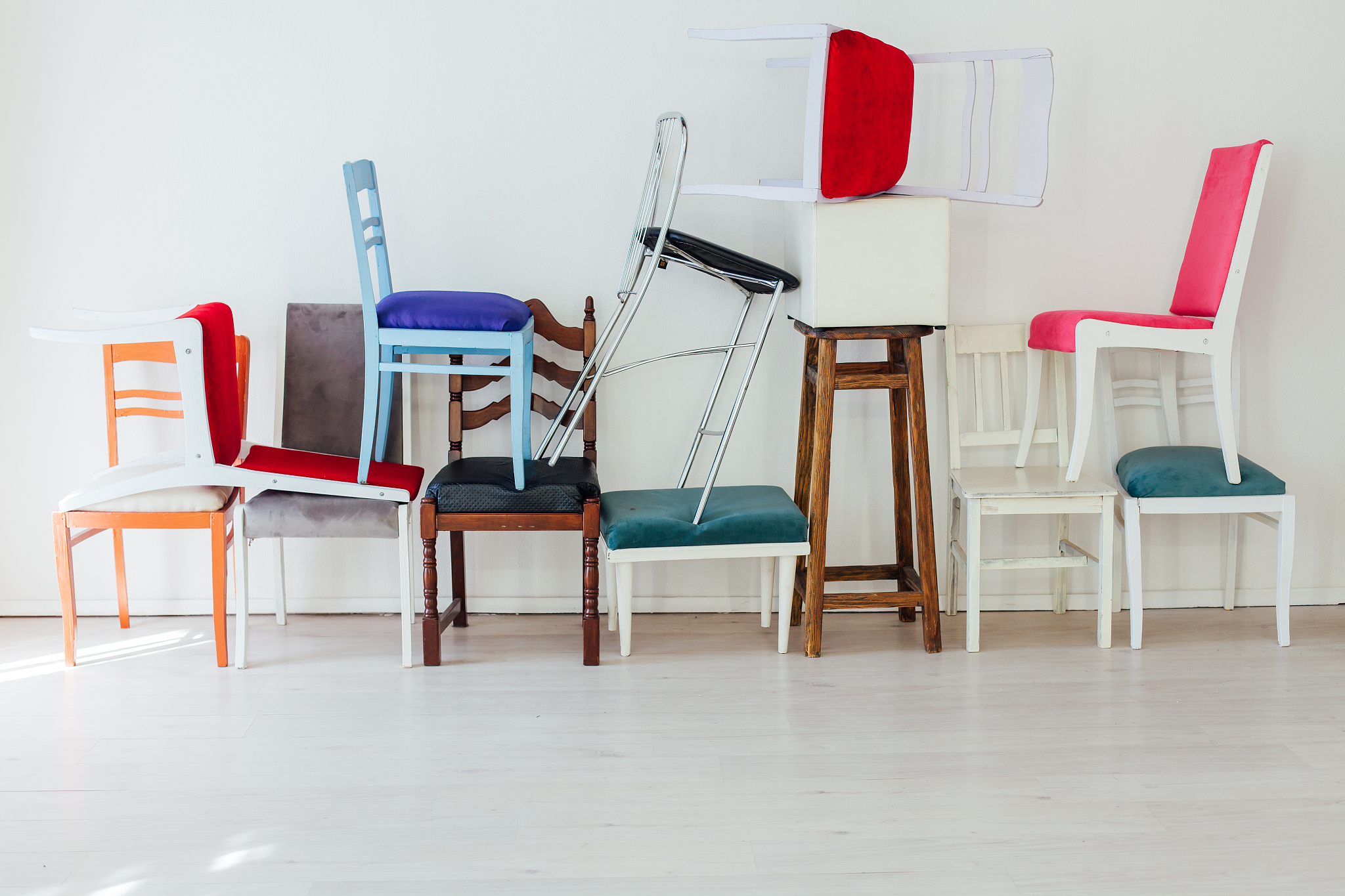 lots of multicolored chairs in the interior of the white room