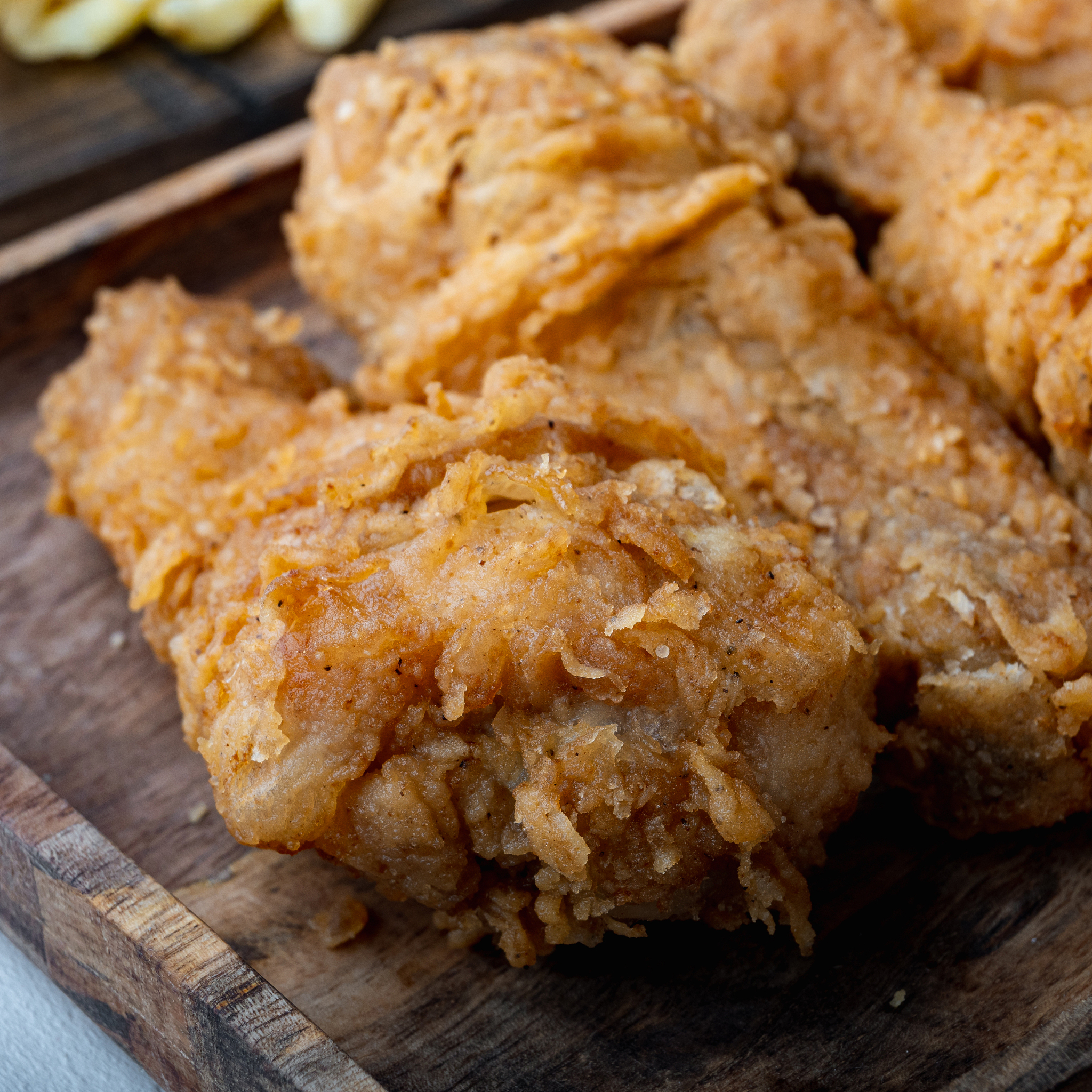 fried crispy chicken legs, drumstick  on grey background