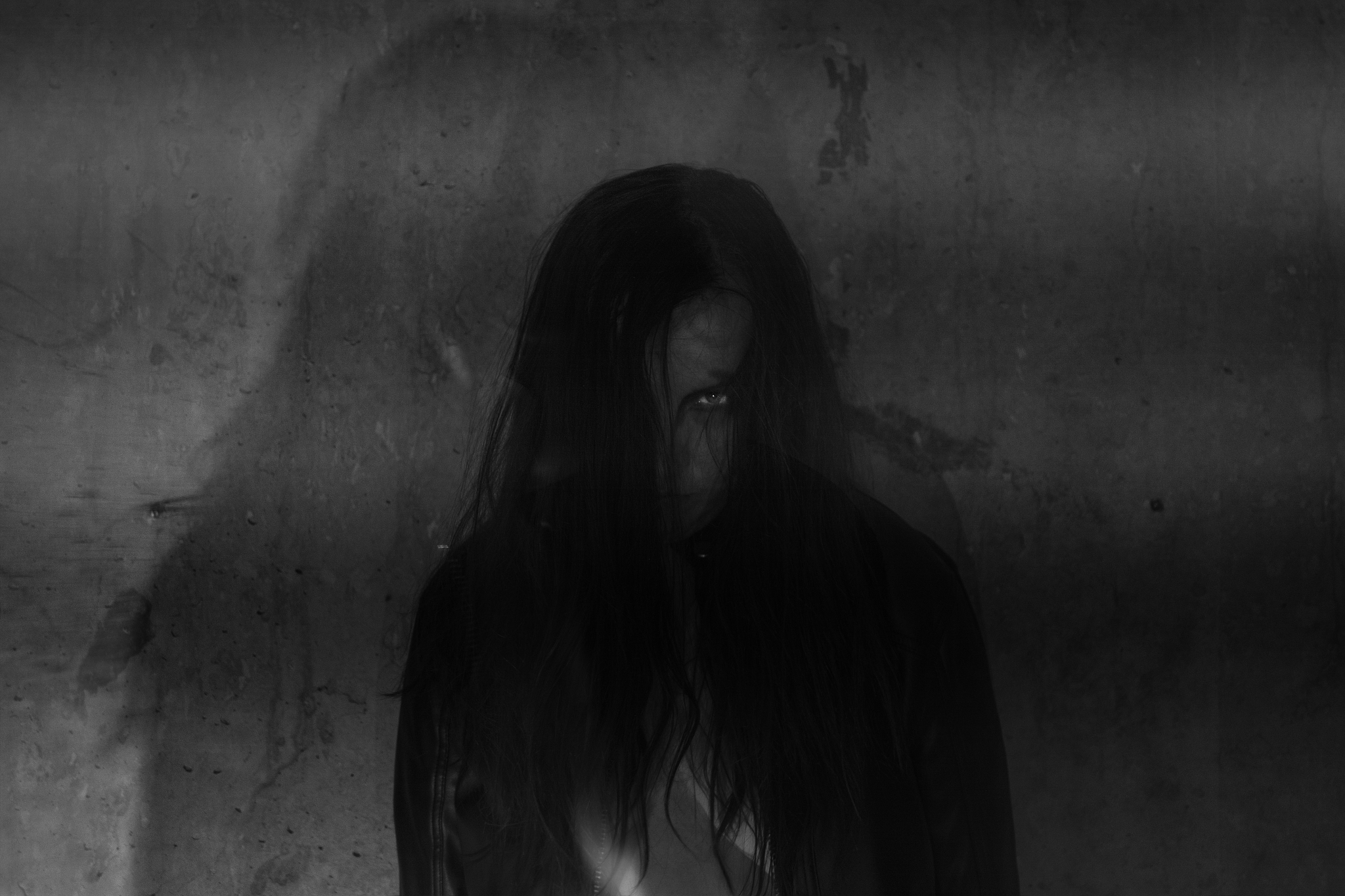 portrait of spooky woman against wall