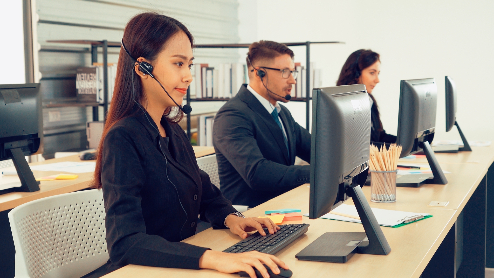 business people wearing headset working in office