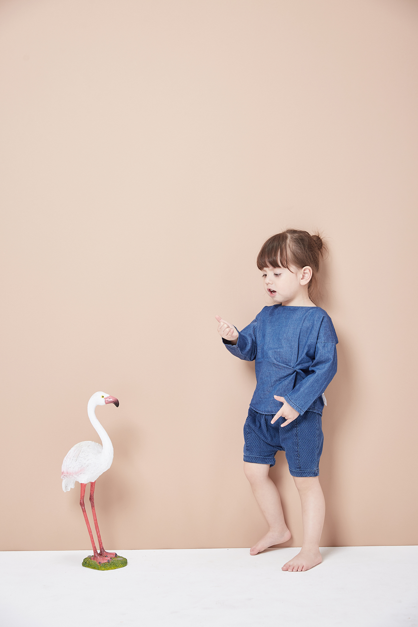 a lively and cheerful little girl, jumping and having fun.