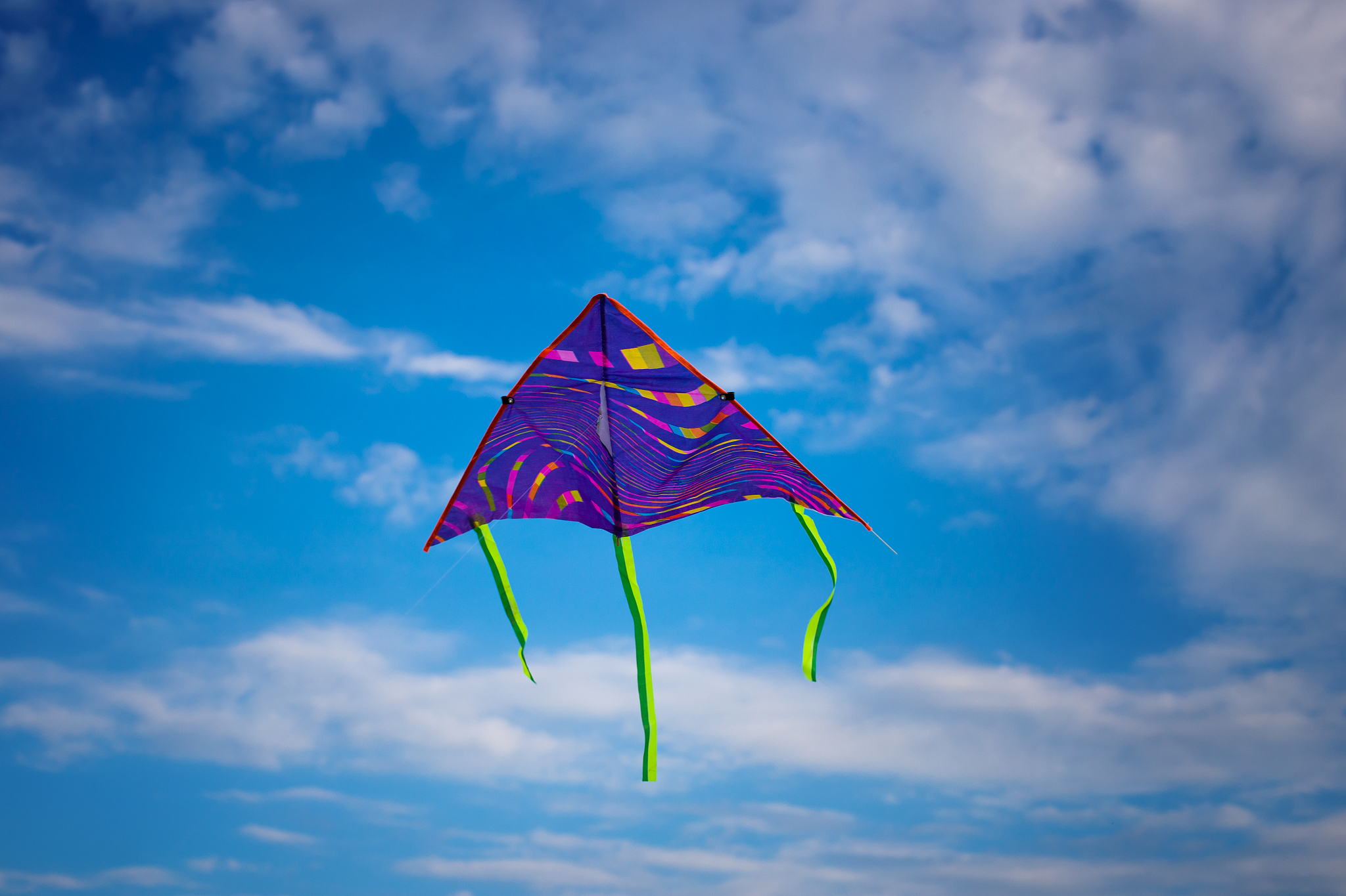 kite flying in the sky among the clouds