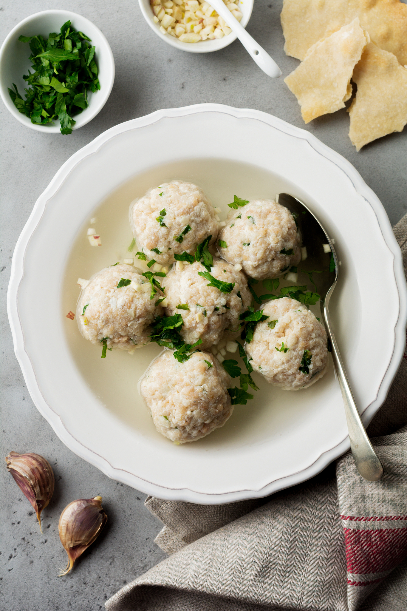 homemade chicken matzo ball soup with parsley and garlic in simp