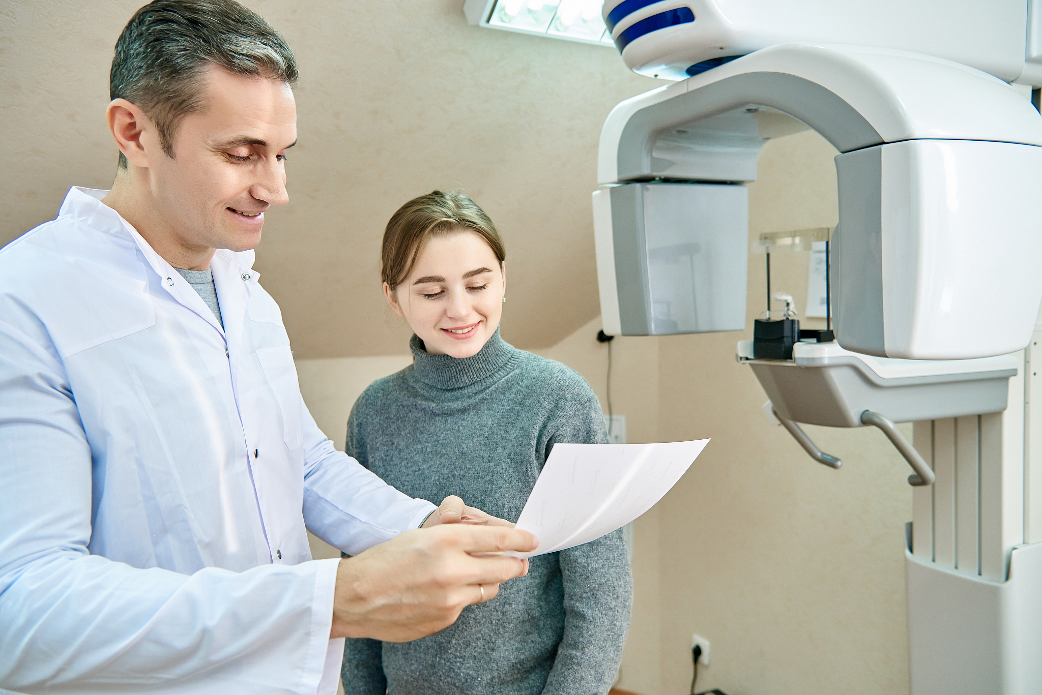 the doctor shows the patient an x-ray image. computer diagnostic