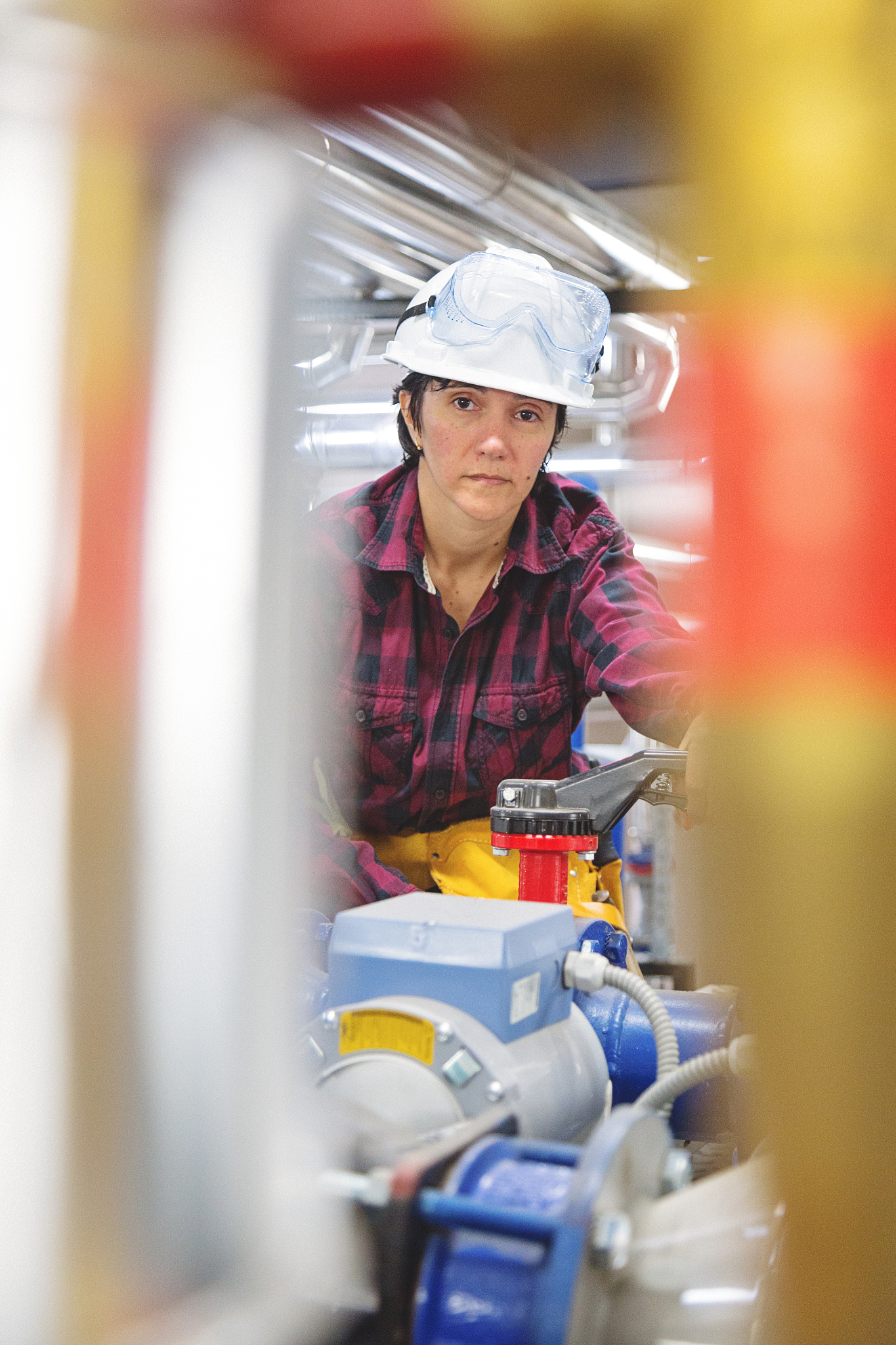 technician working on valve in factory or utility