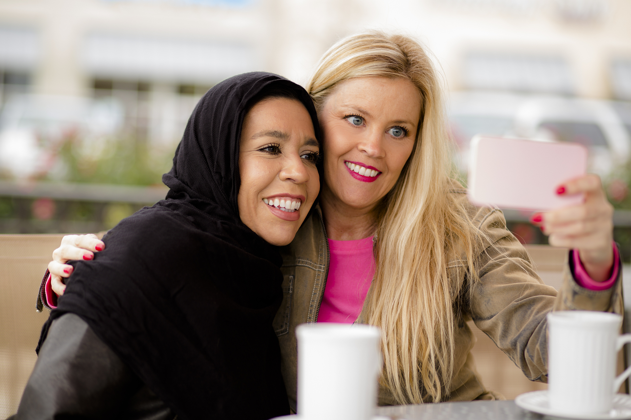 friendship.  muslim woman and her friend take selfie.