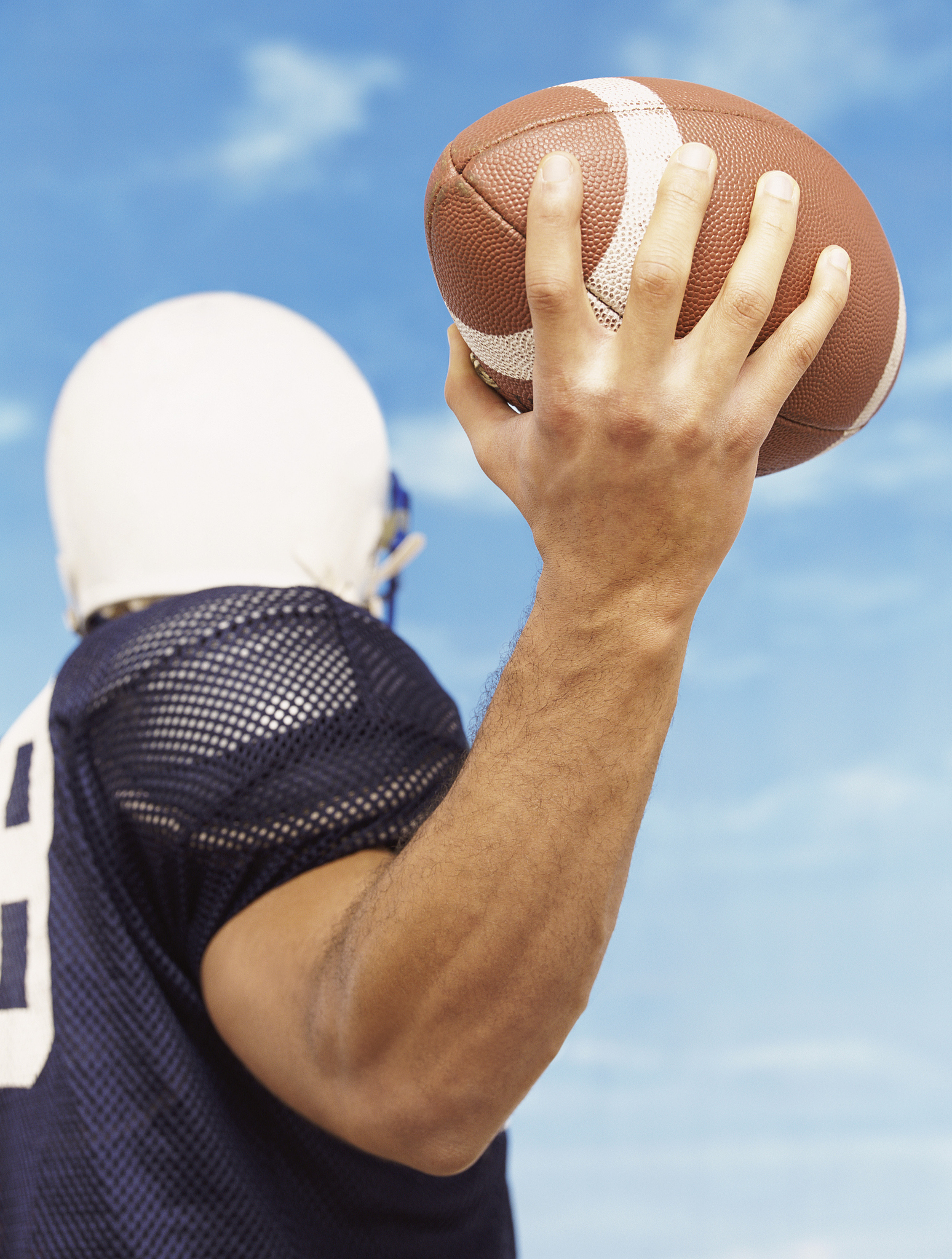 american football player holding a ball