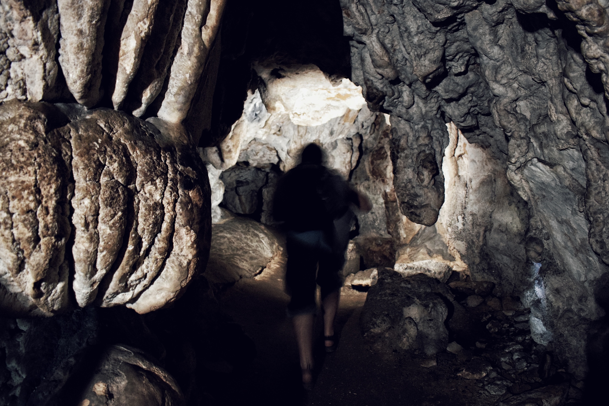 rear view of a person in a  cave
