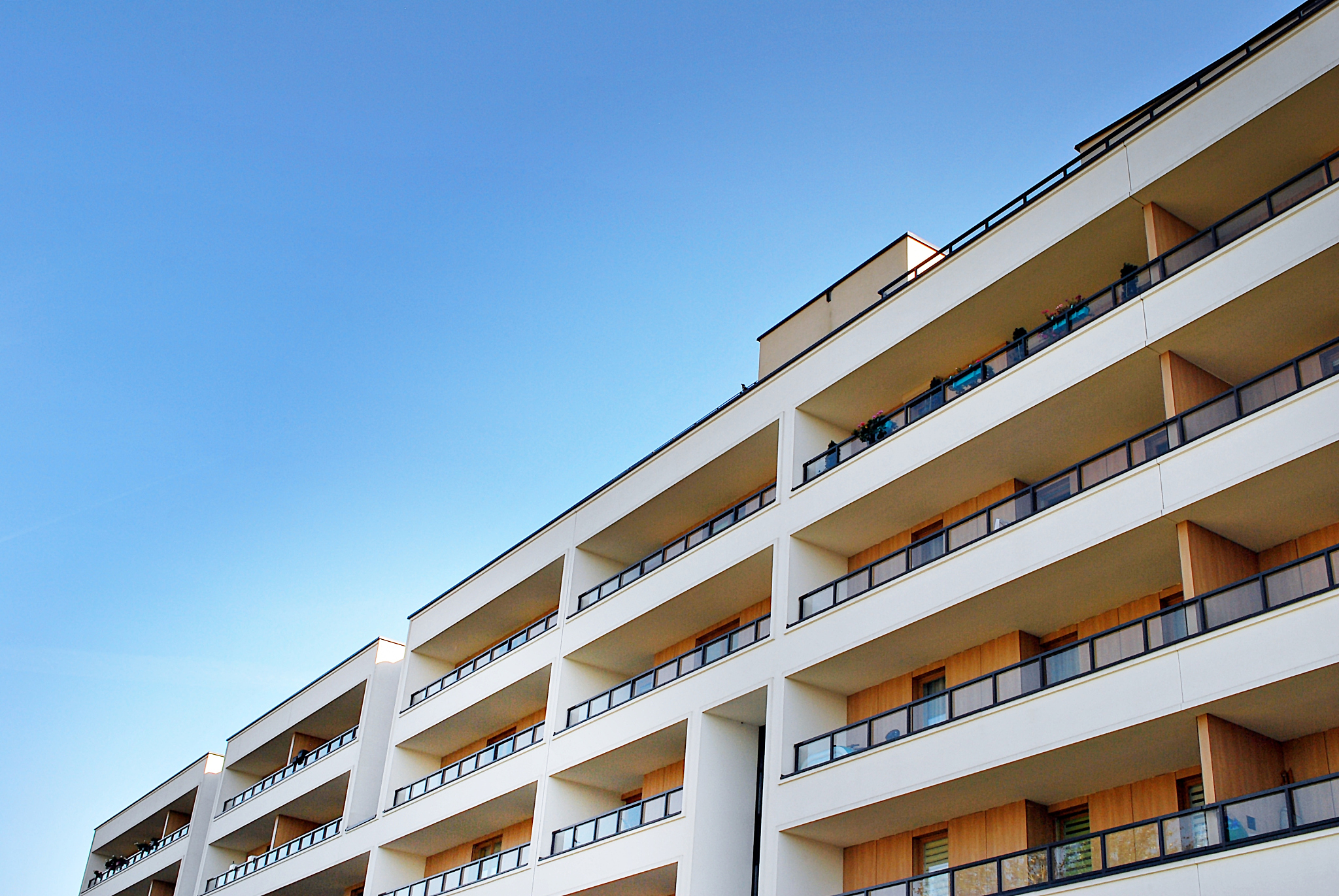 modern, luxury apartment building against blue sky