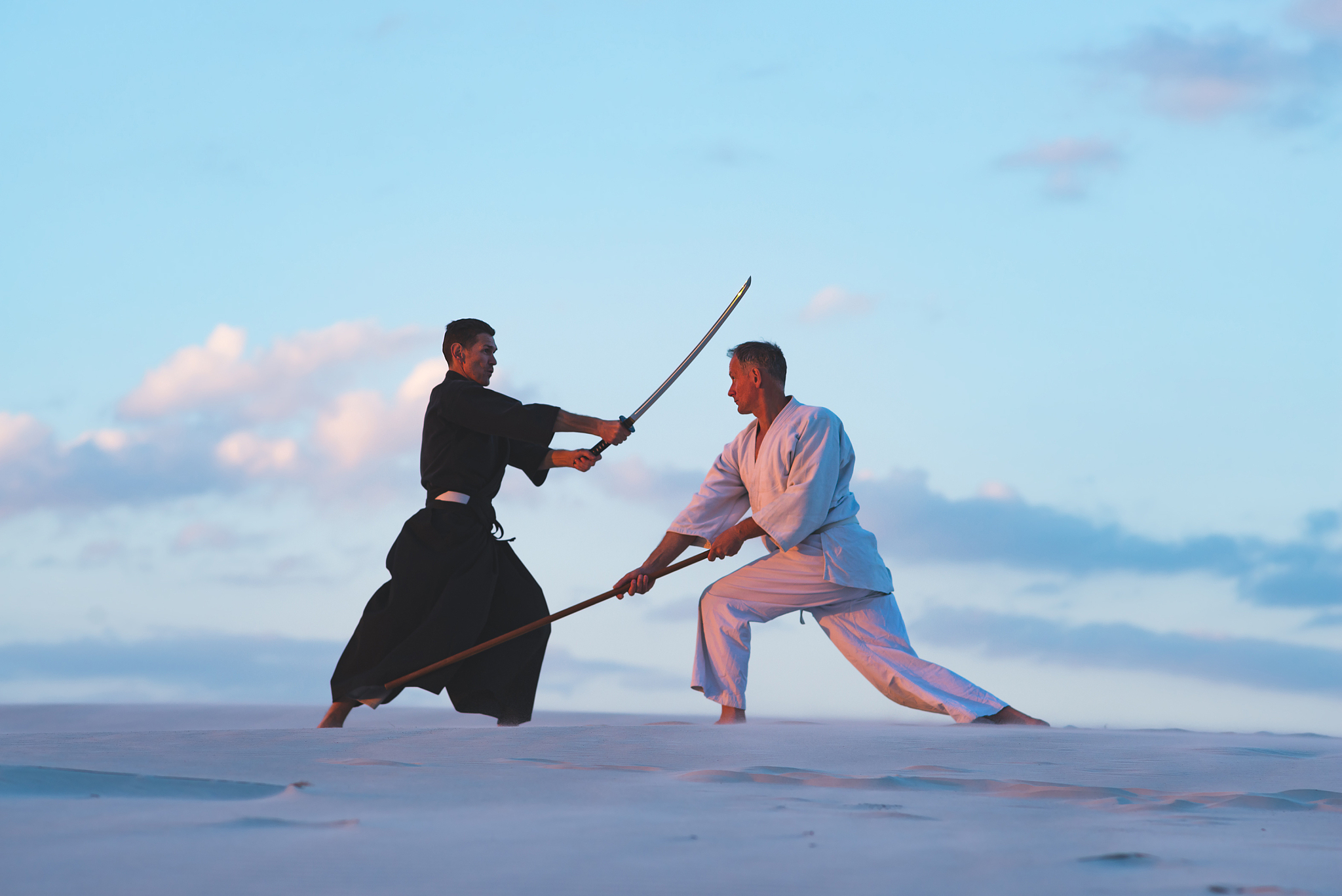 concentrated men, in japanese clothes, are practicing martial ar
