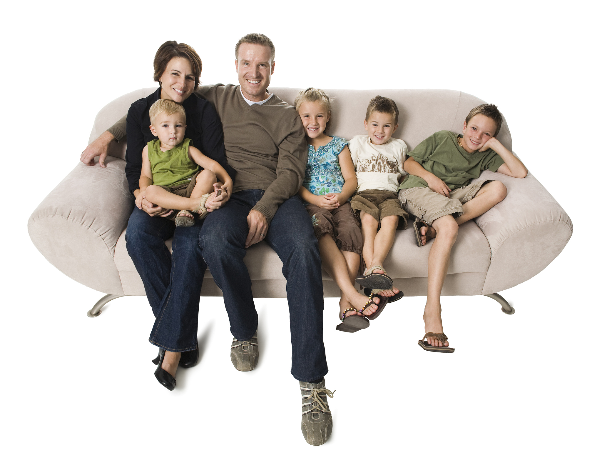 family sitting on a couch smiling