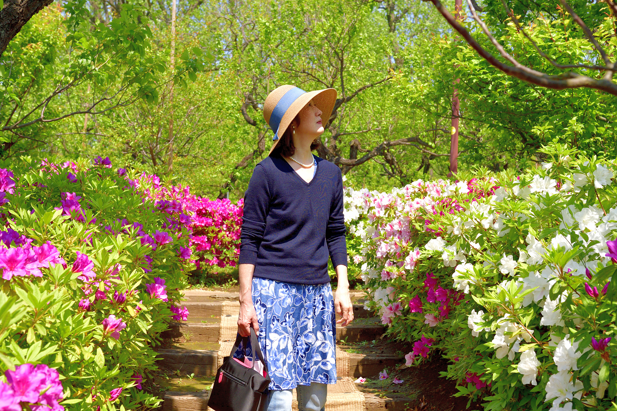 japanese woman enjoying walking in tokyo public park with azalea