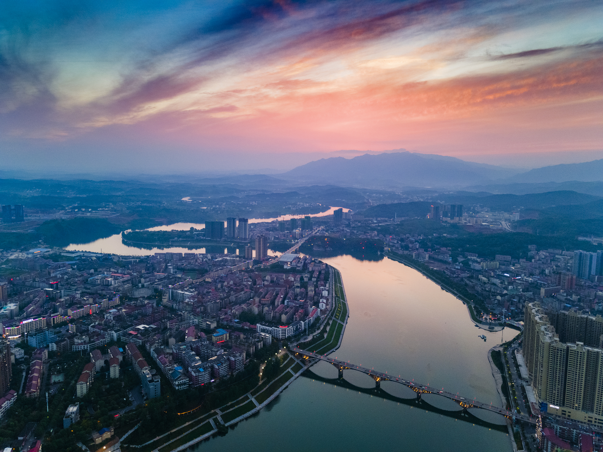 high angle view of city against sky during sunset