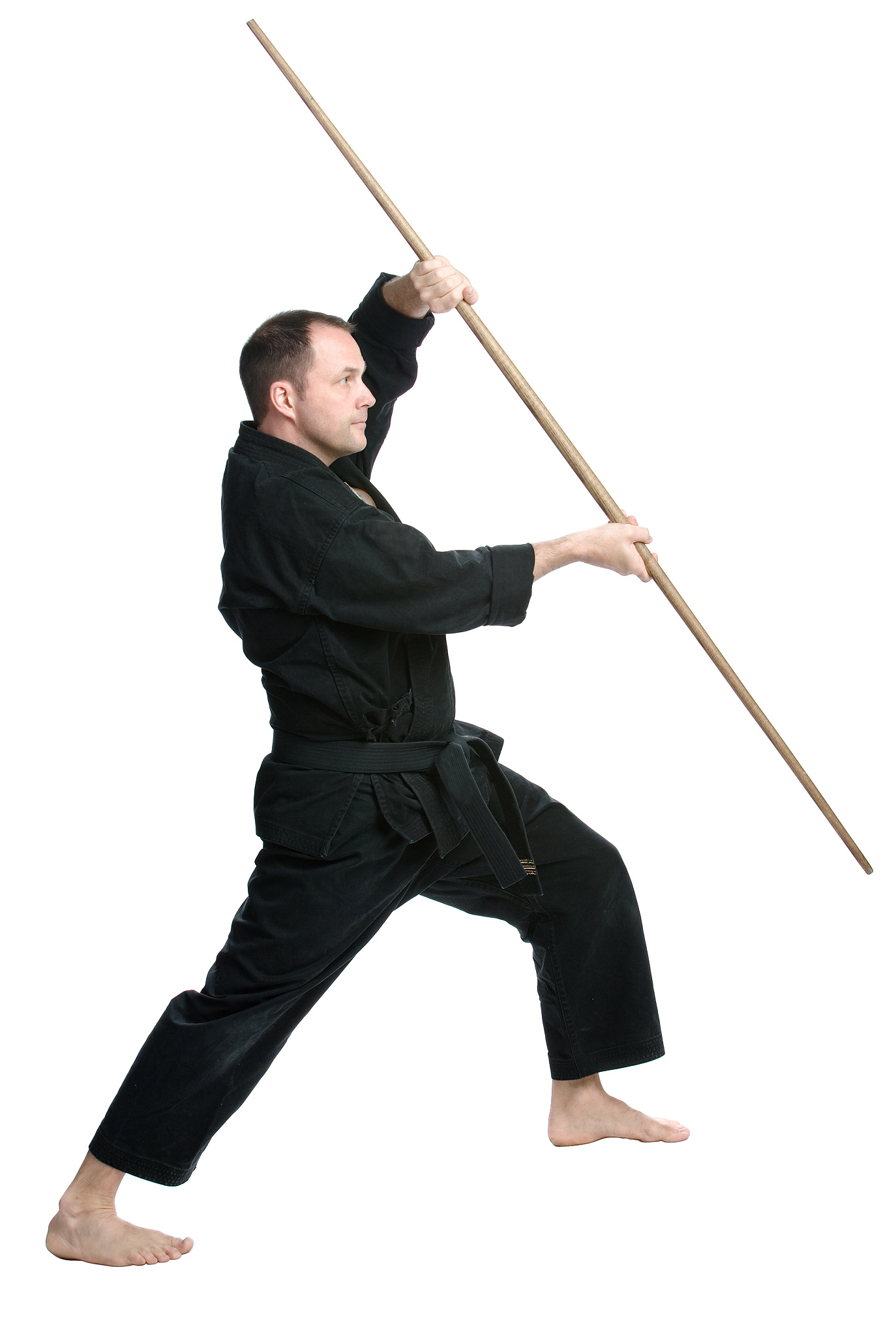 man in martial arts uniform using bo staff weapon