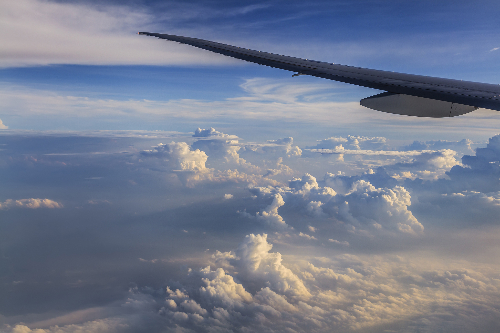 airplane wing against a background of clouds. view from the wind