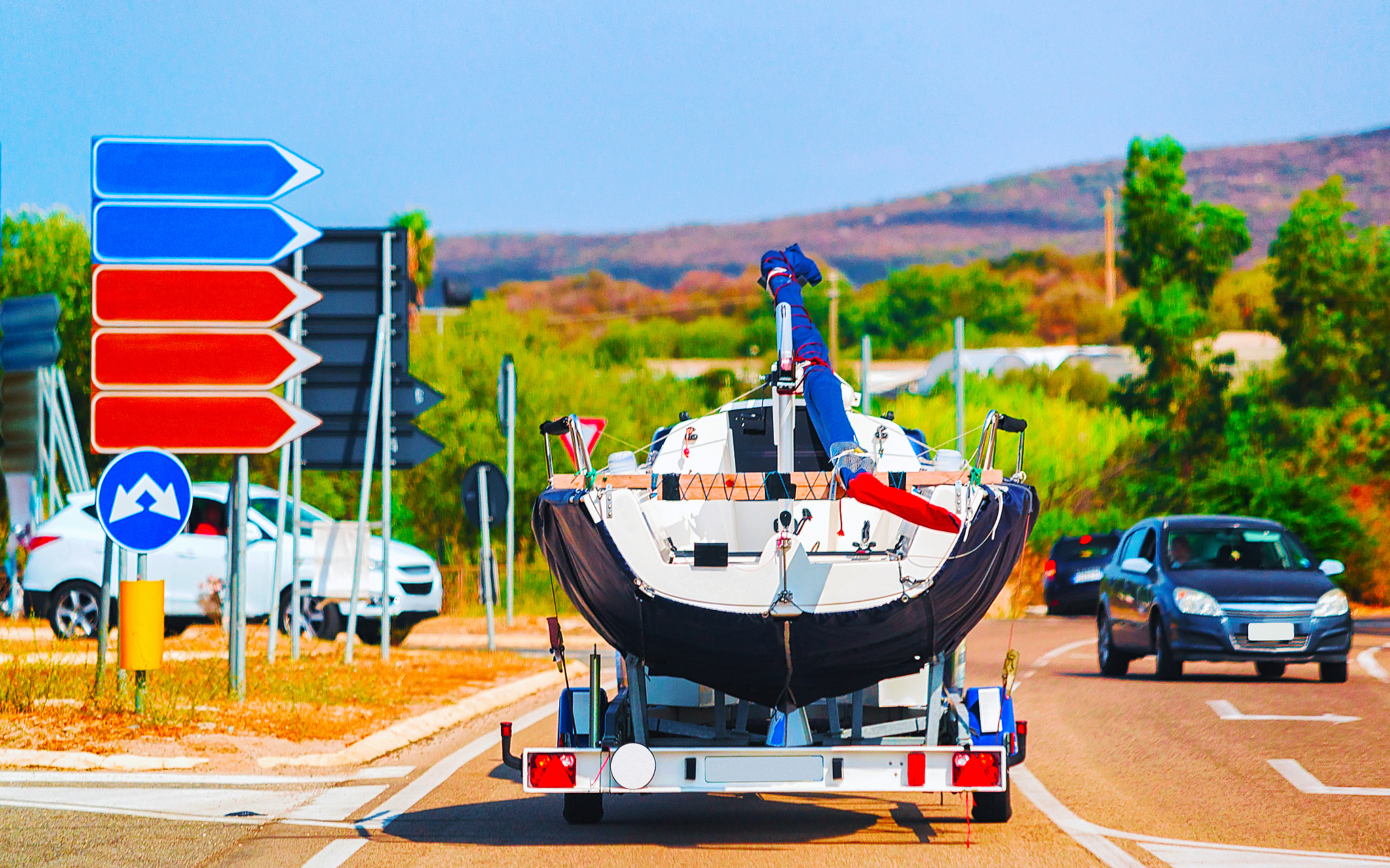 car with motor boat on trailer on road of olbia reflex