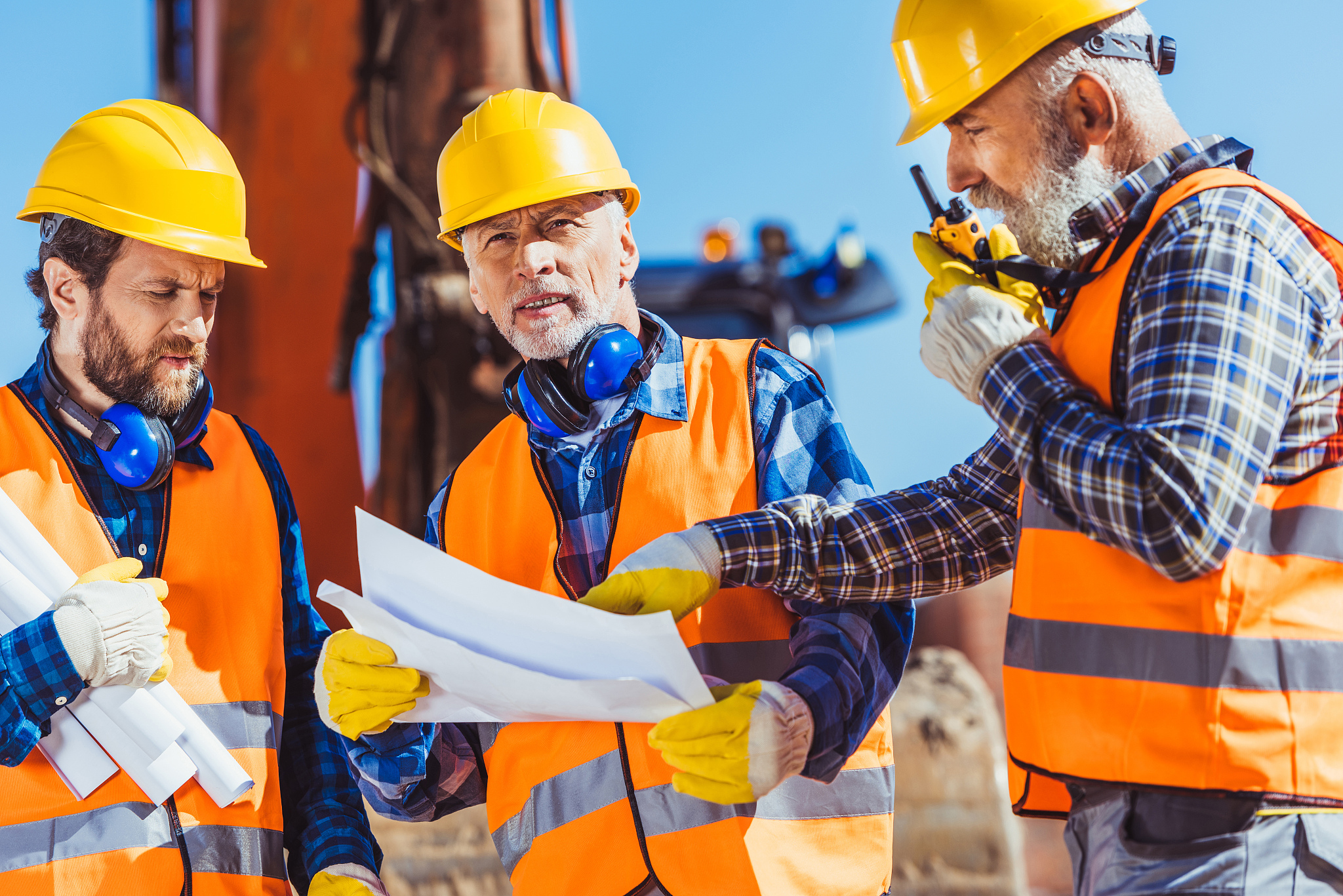 construction workers examining building plans