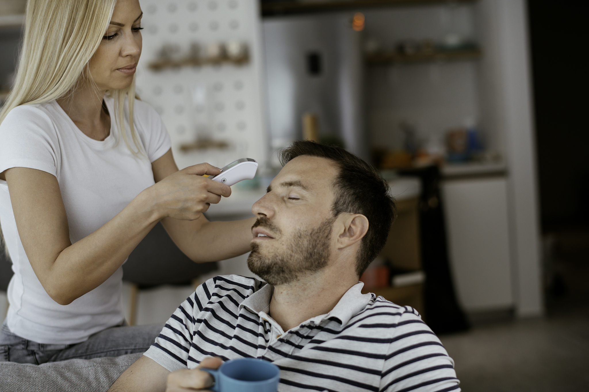 sick man with fever lying in bed having temperature girl take ca