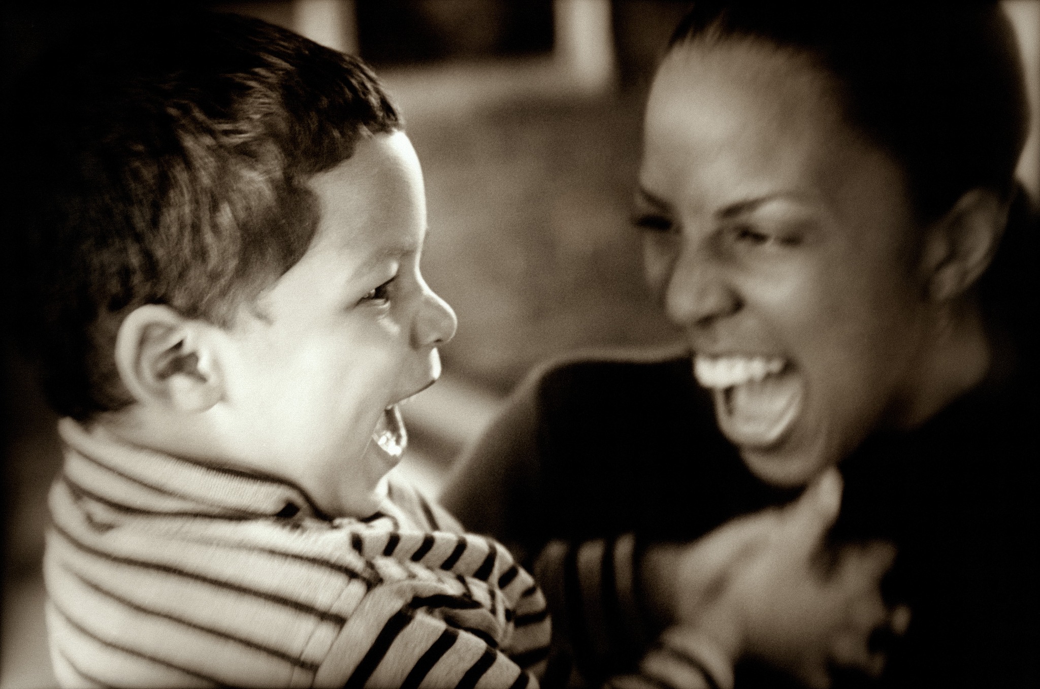 mother and son laughing, close up